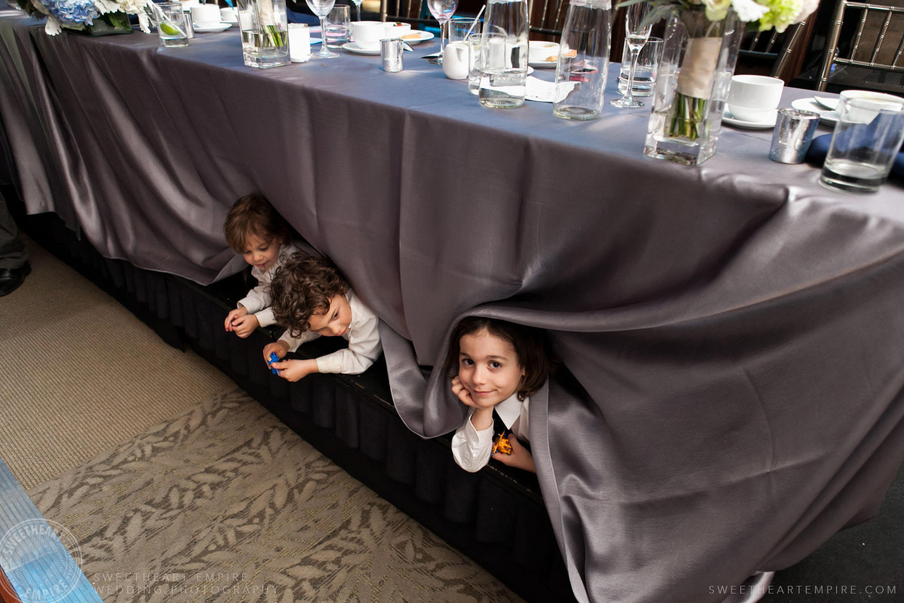 Kids hiding under bride and groom's table; Eagles Nest Golf Club Wedding
