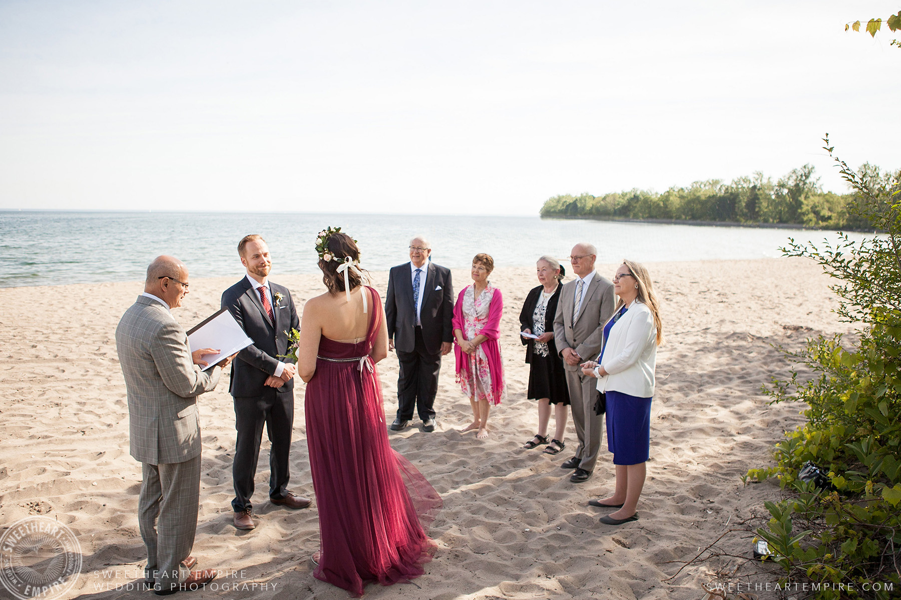 Family members look on as bride and groom exchange their vows, Toronto Island Elopement