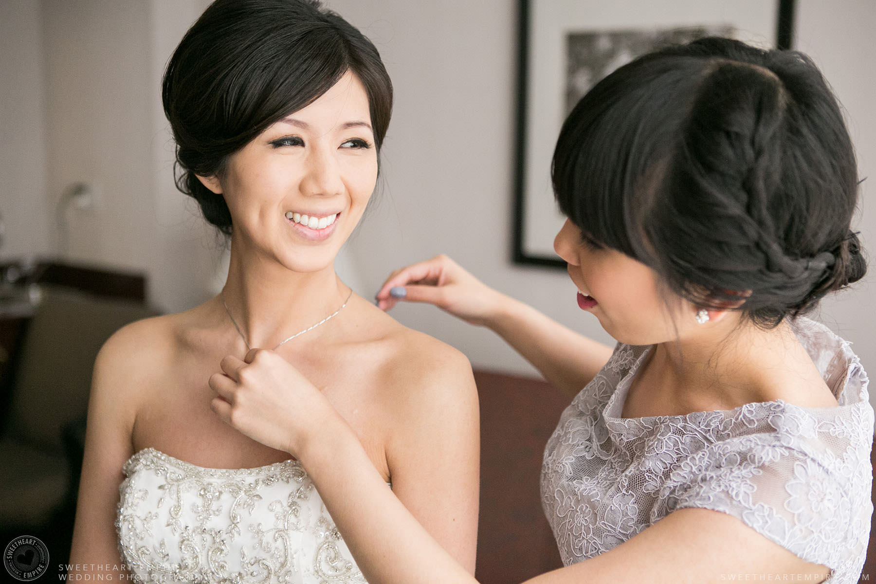 Bride putting on her necklace, Hart House University of Toronto Wedding