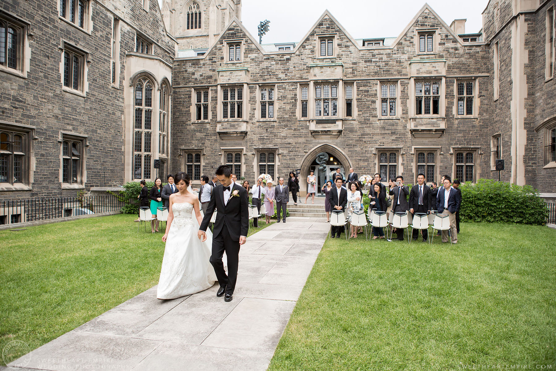 Bride and groom walking down the aisle after being married, Hart House University of Toronto Wedding