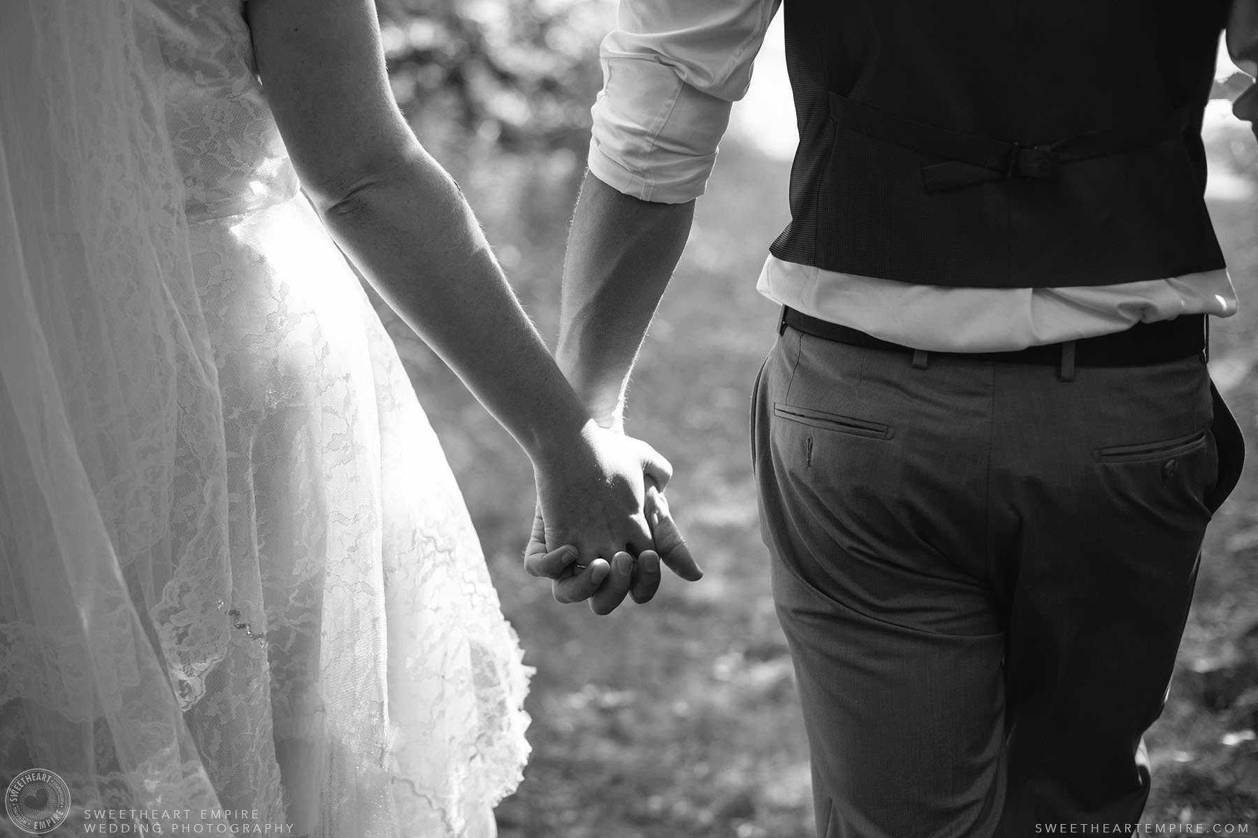 Bride and groom holding hands; Aberfoyle Mill Wedding