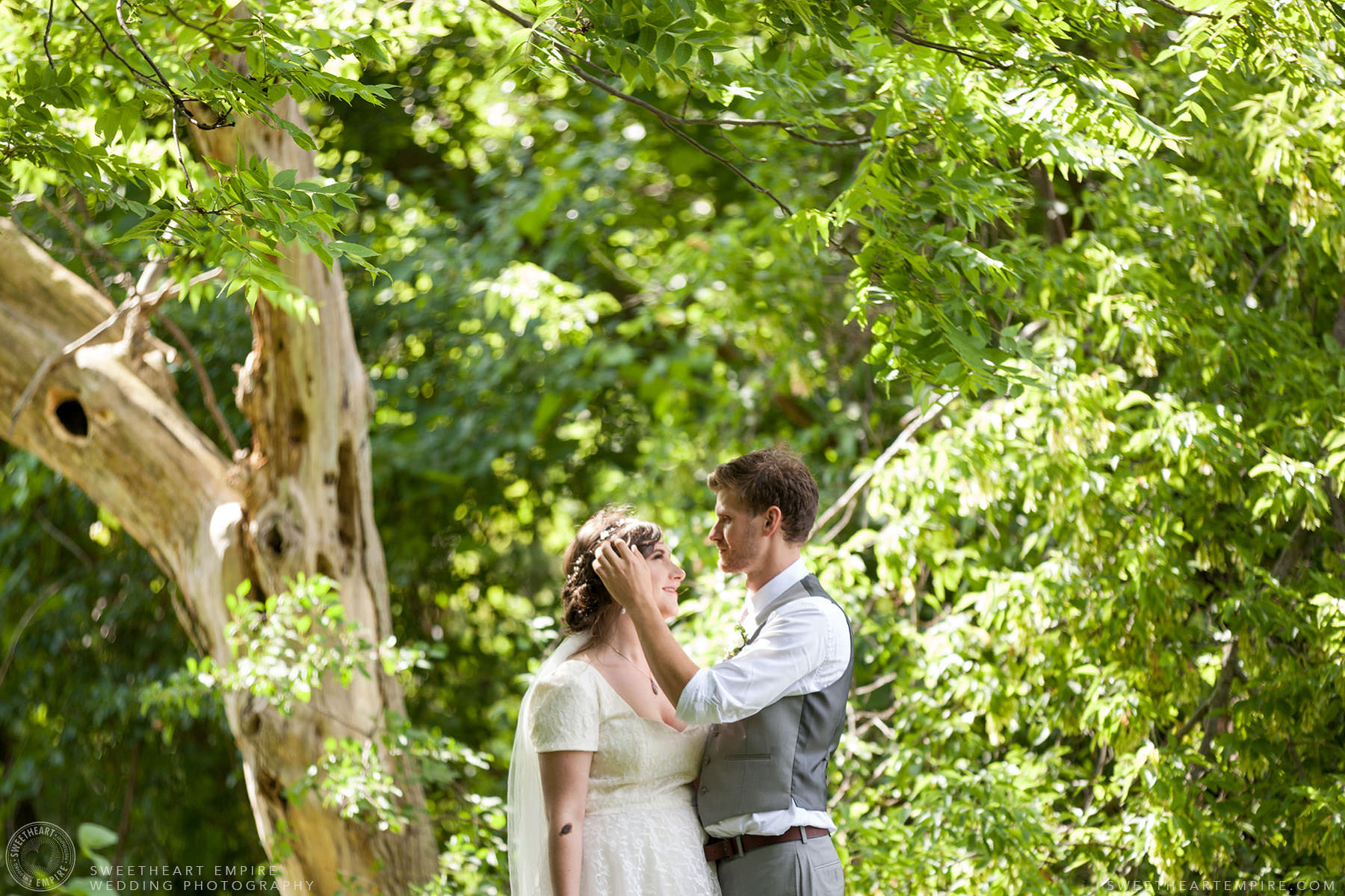 Groom caressing the bride's hair; Aberfoyle Mill Wedding