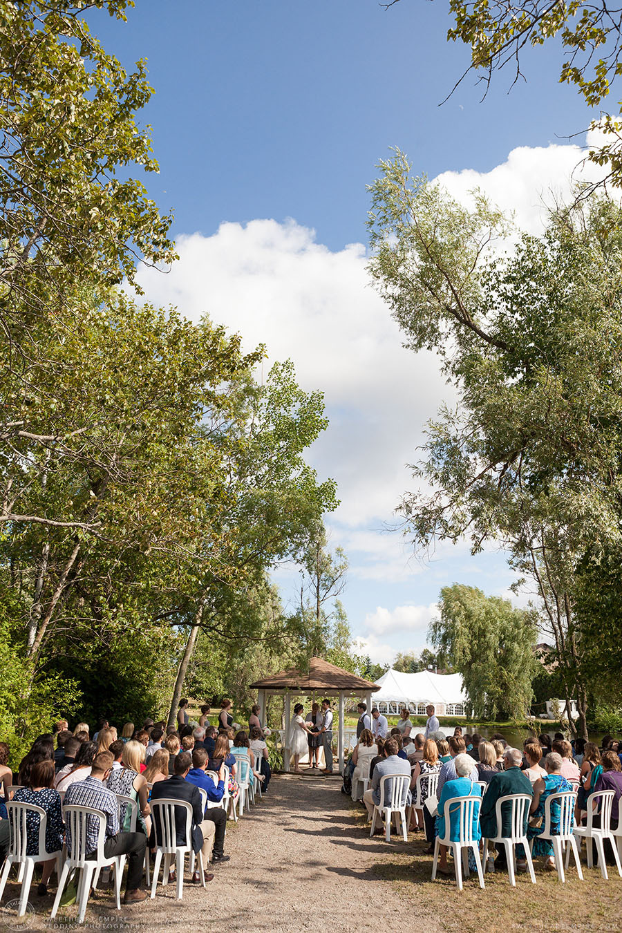 Bride and groom exchanging vows during outdoor ceremony; Aberfoyle Mill Wedding