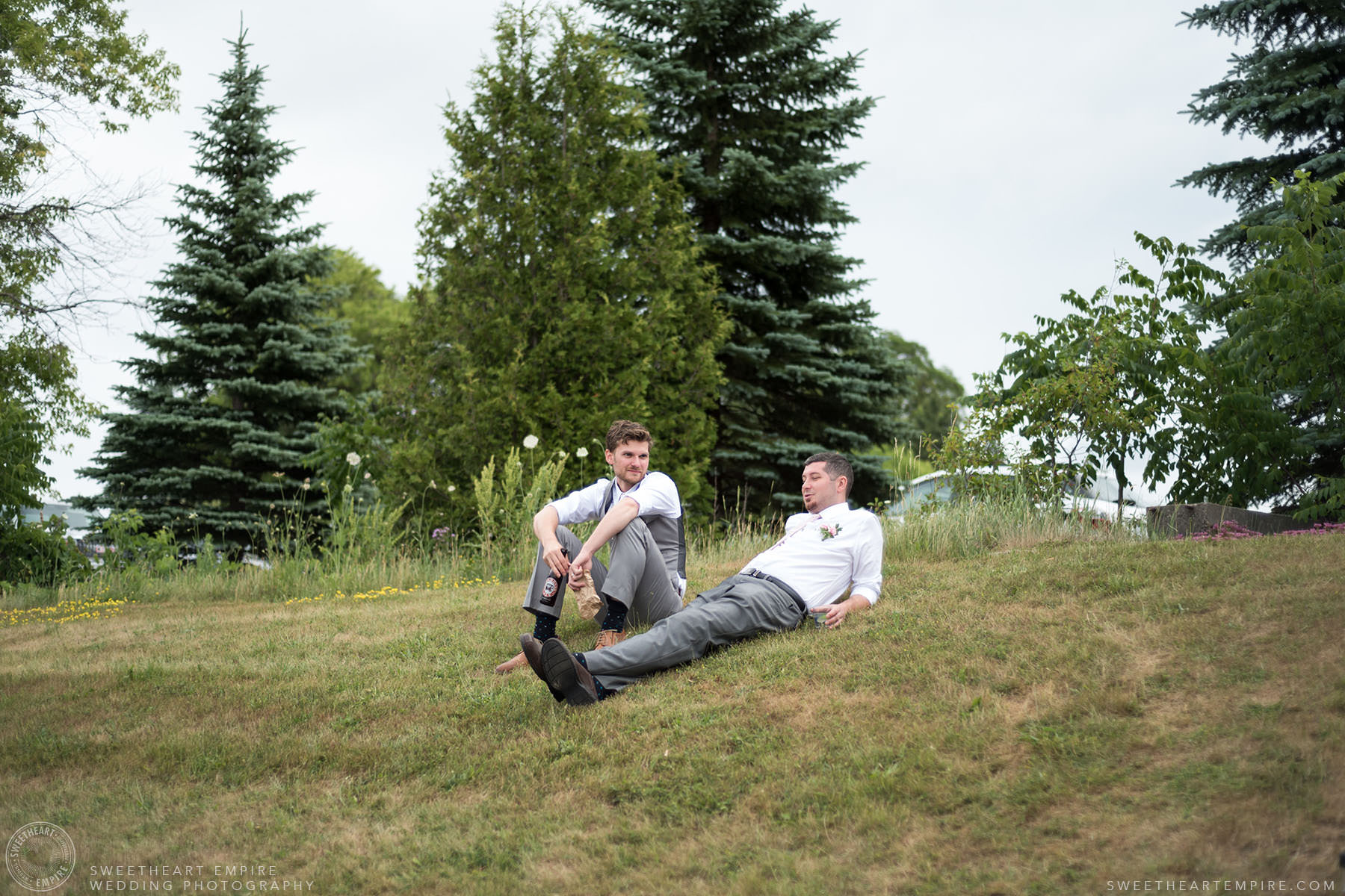 Groom and his best man relaxing on the grass; Aberfoyle Mill Wedding