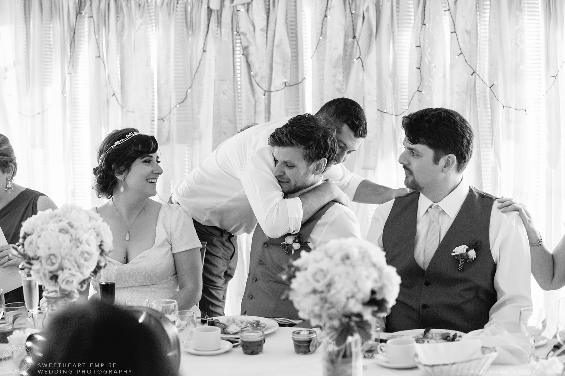 Groom getting a hug from a friend; Aberfoyle Mill Wedding
