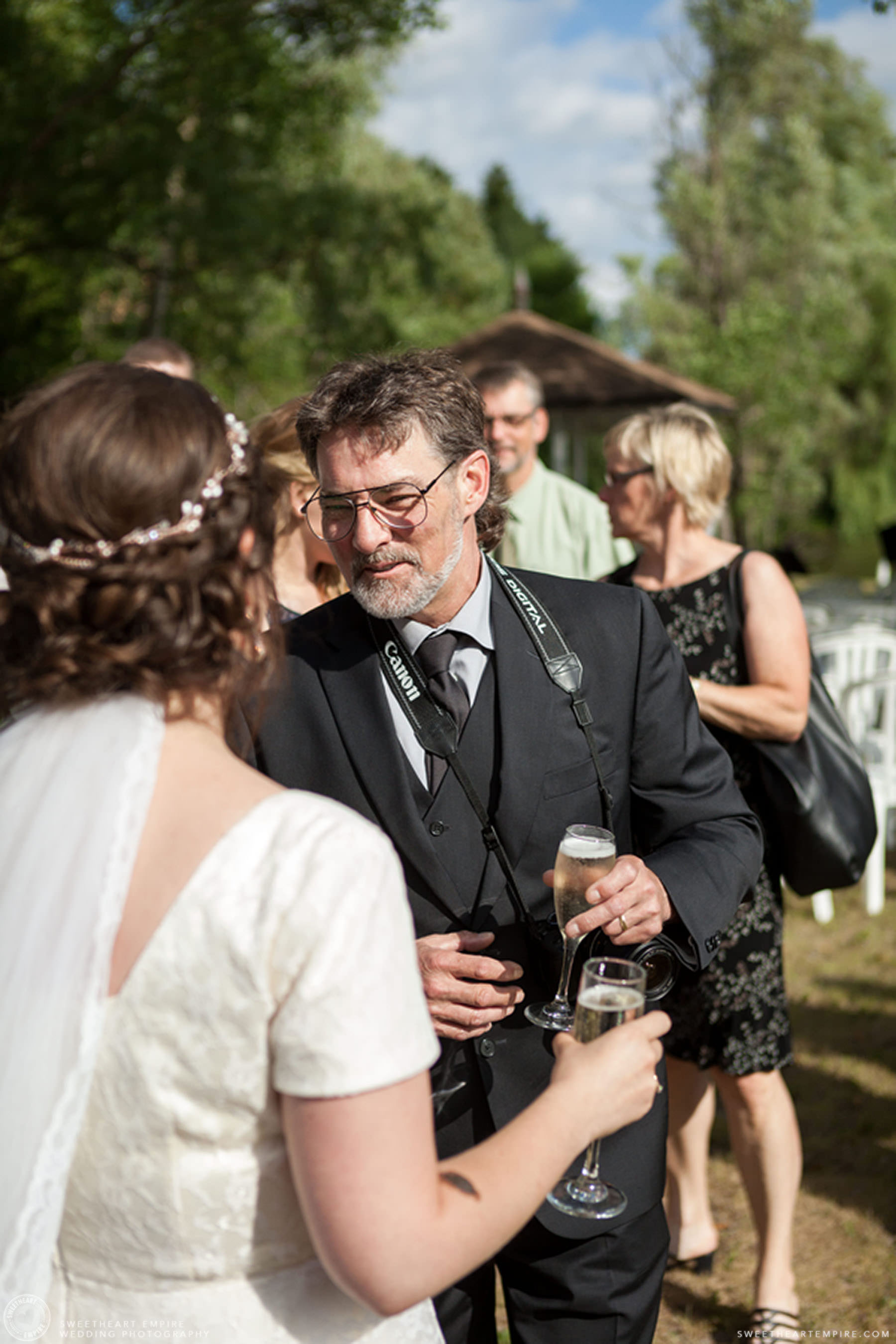 Bride having champagne with one of her guests; Aberfoyle Mill Wedding