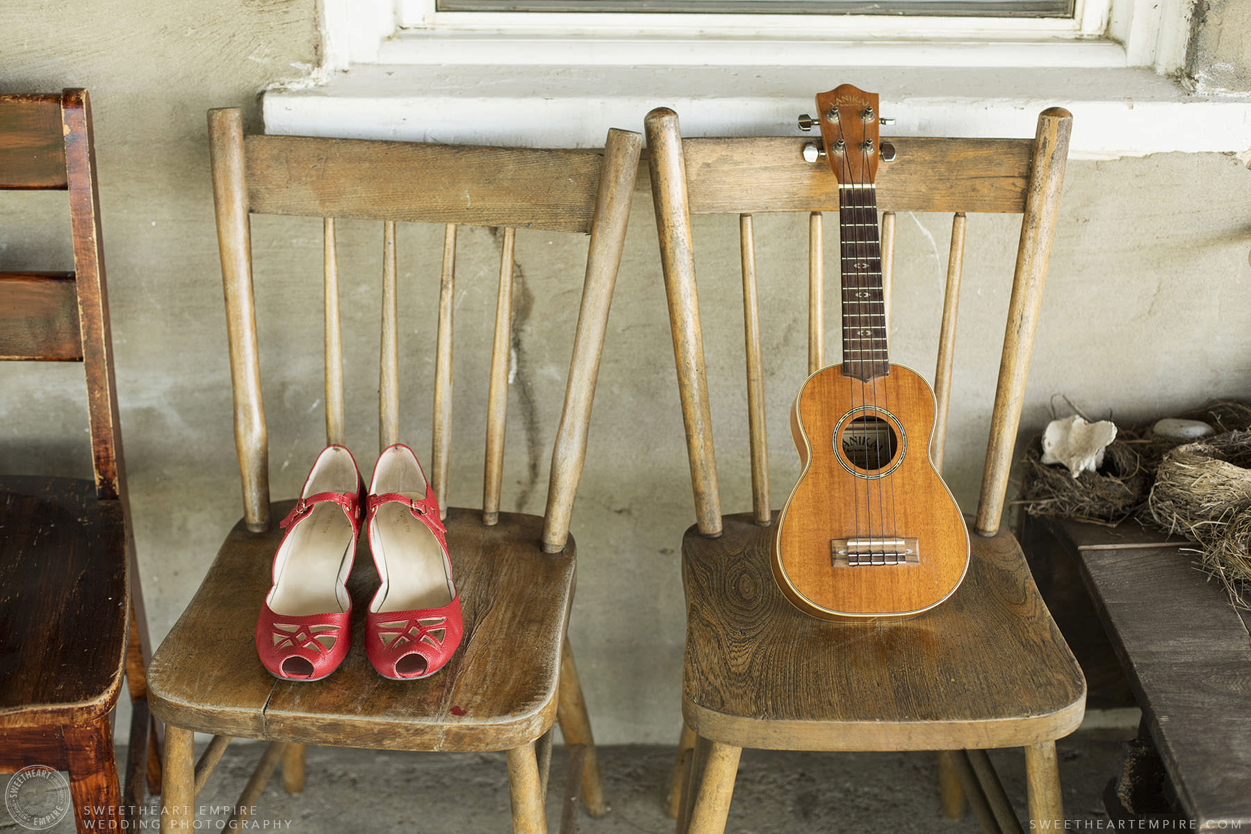 Bride's vintage red shoes and groom's ukulele.