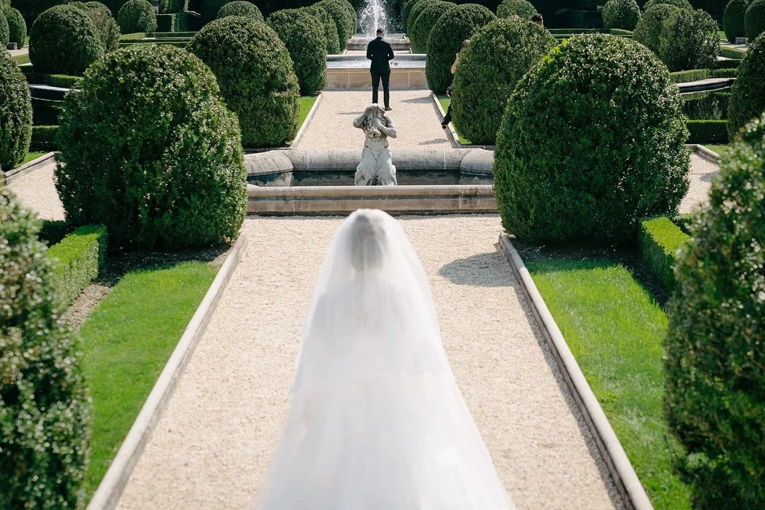 bride and groom first look in oheka castle gardens