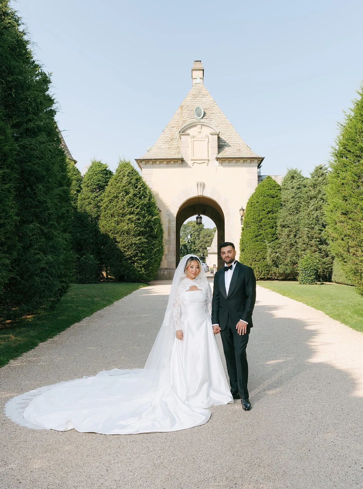 bride and groom portrait at entrance of oheka castle