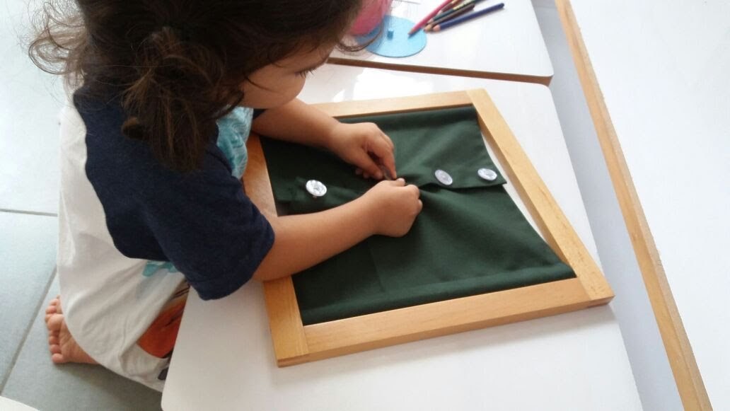 Using the button frames to practice fine motor skills