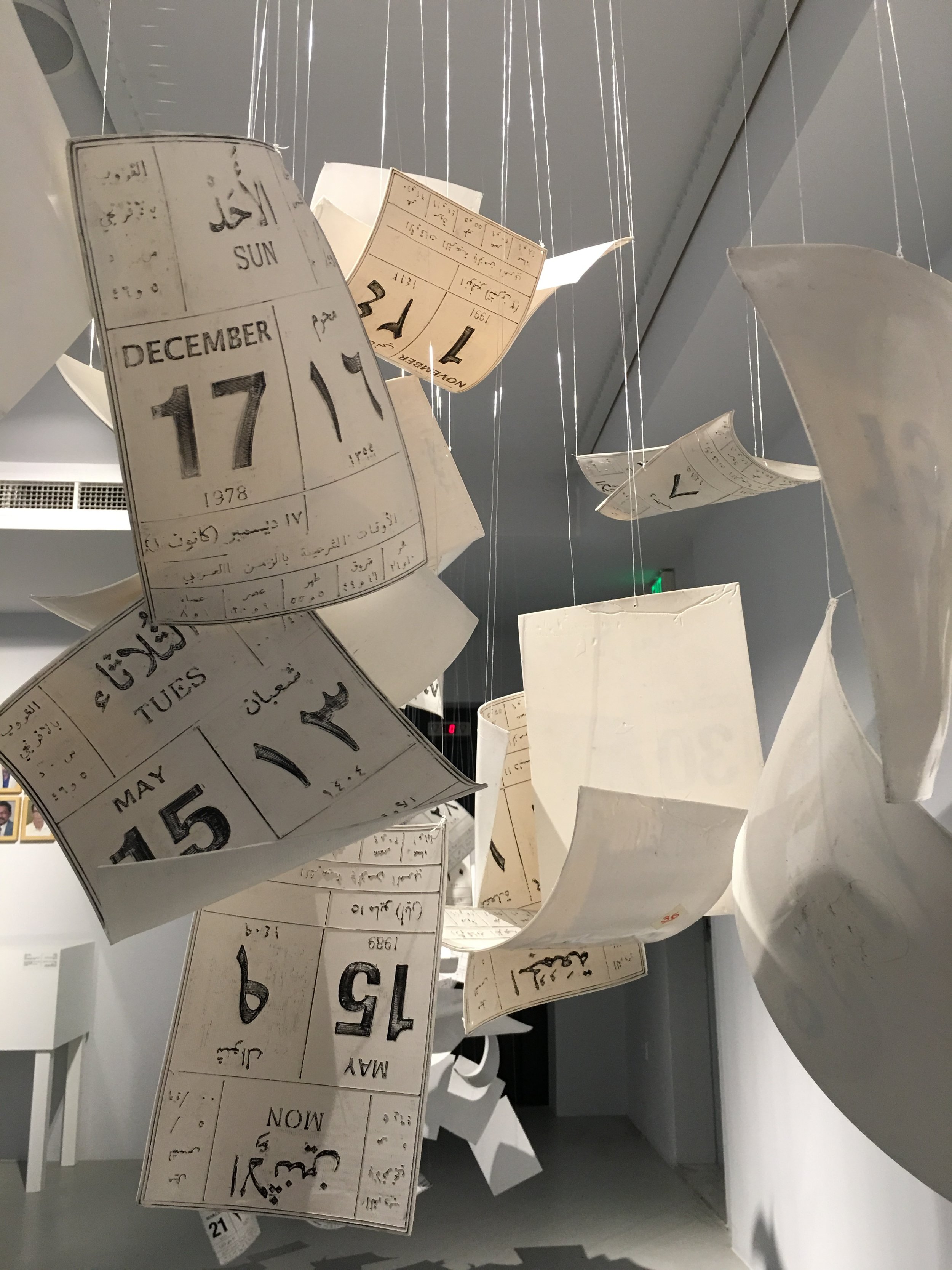 Saswan Al Bahar, Wra'a II Zaman (Leaves of Time), 2015, 3D modelled calendar leaves with printed llithography and nylon string. Courtsey of the artist. Part of ADMAF Collection