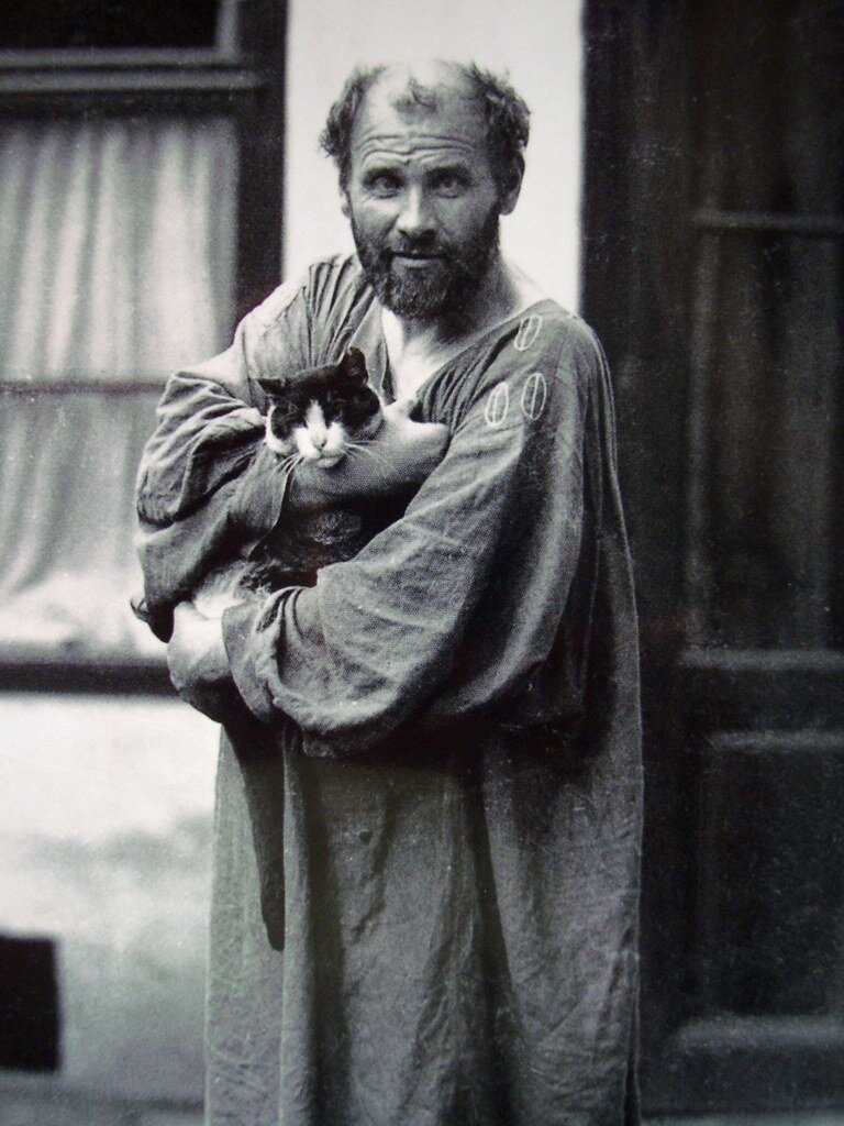 A portrait of Gustav Klimt with a house cat in 1912 by Austrian photographer Moritz Nah