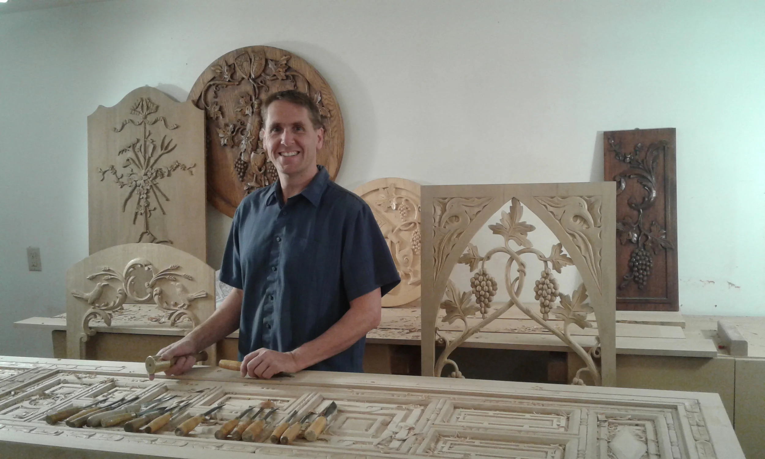 Erik with a collection of his wood carvings