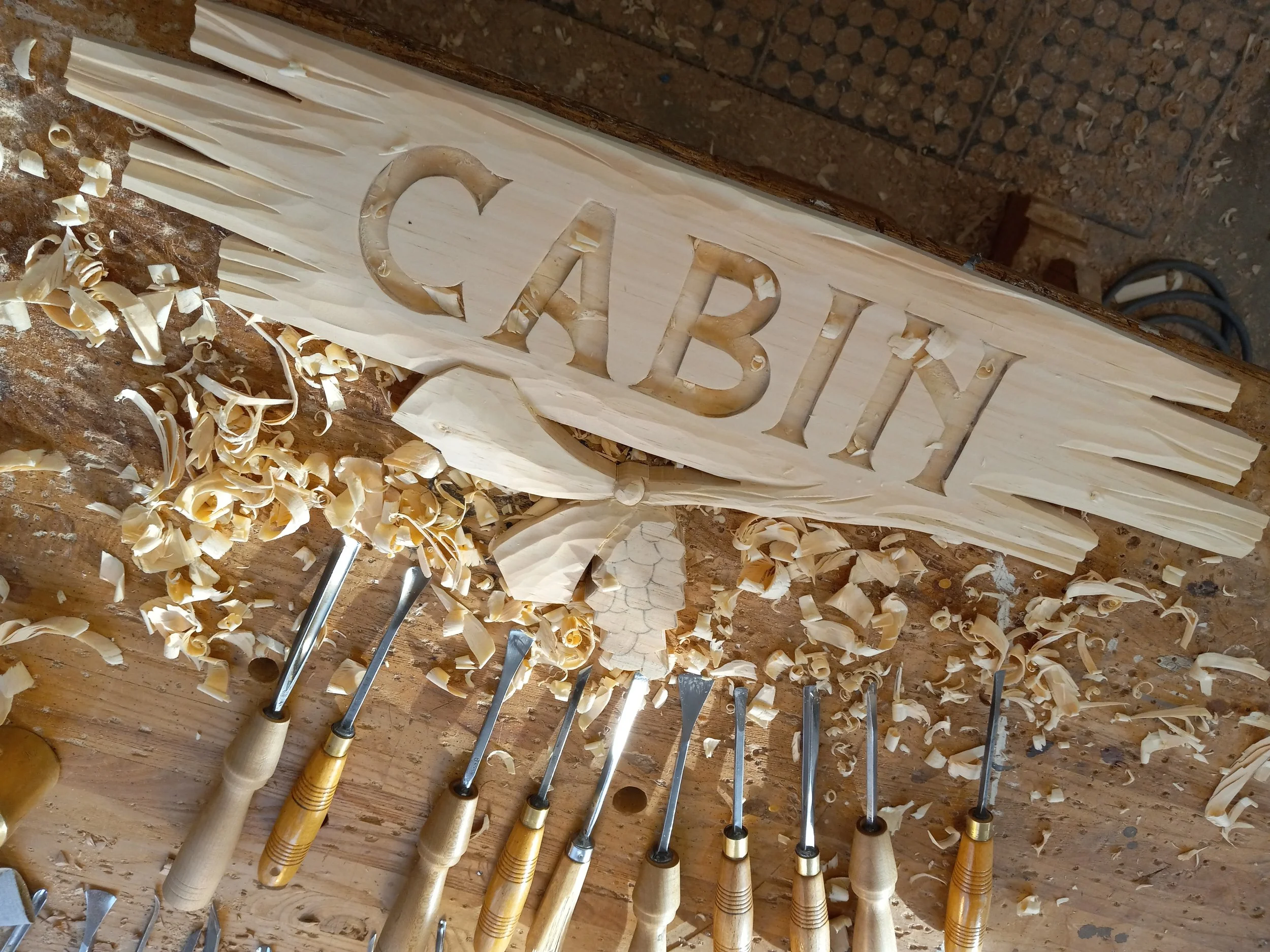 A custom wooden sign on my workbench.