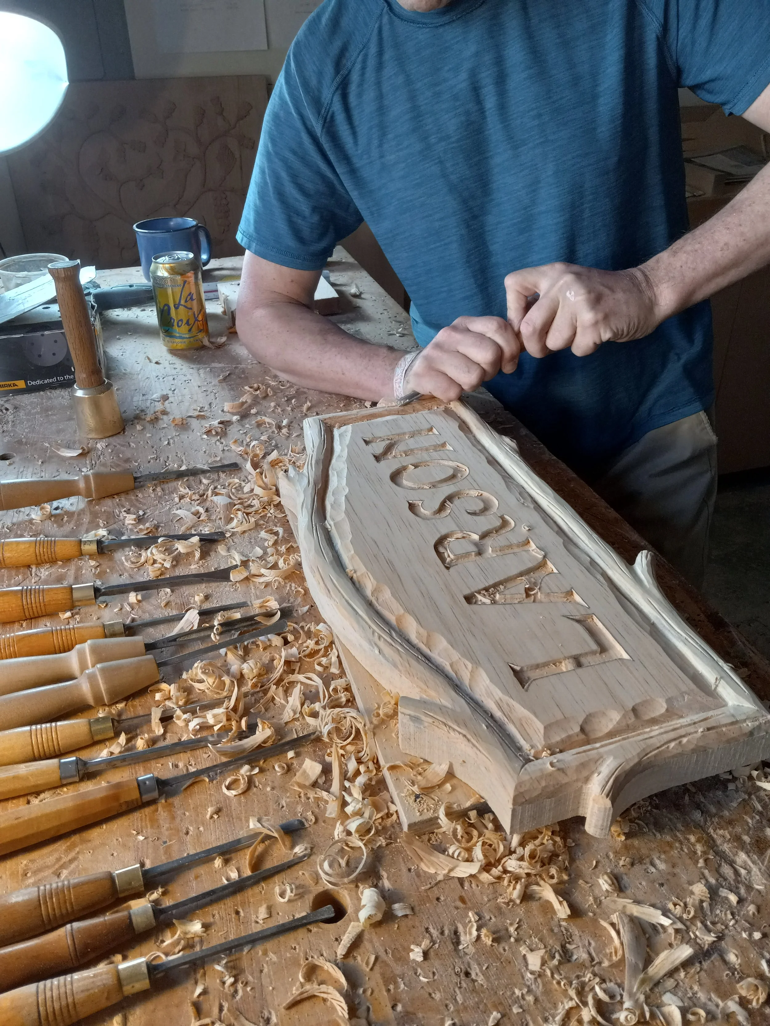 Here I am hand carving a wooden sign.