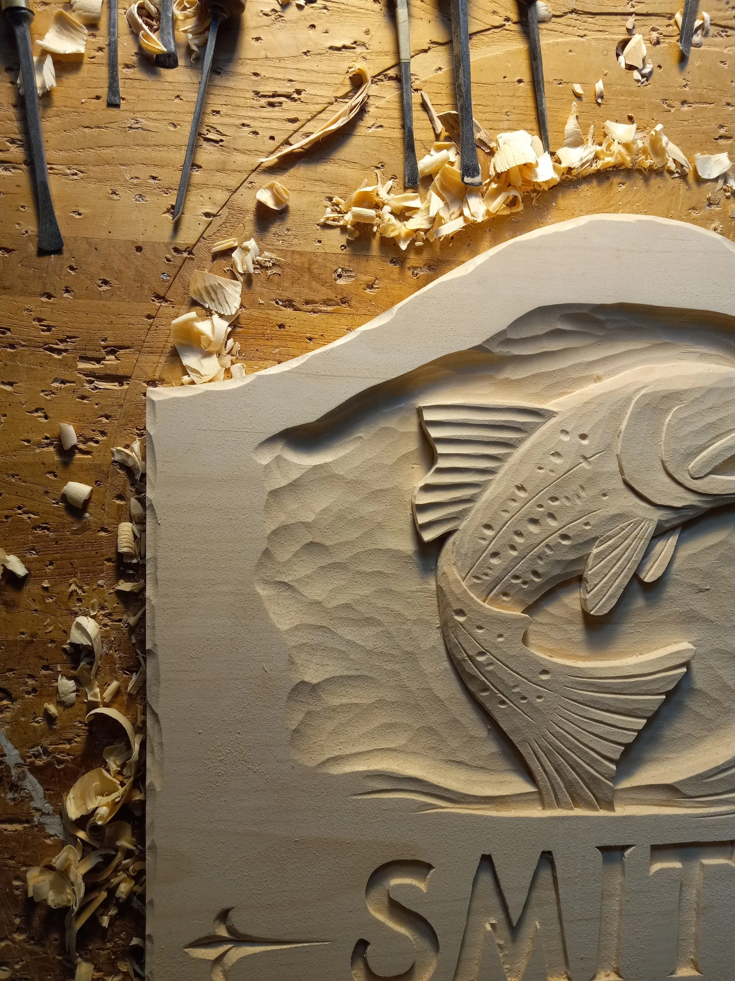 A custom wood sign on my workbench.