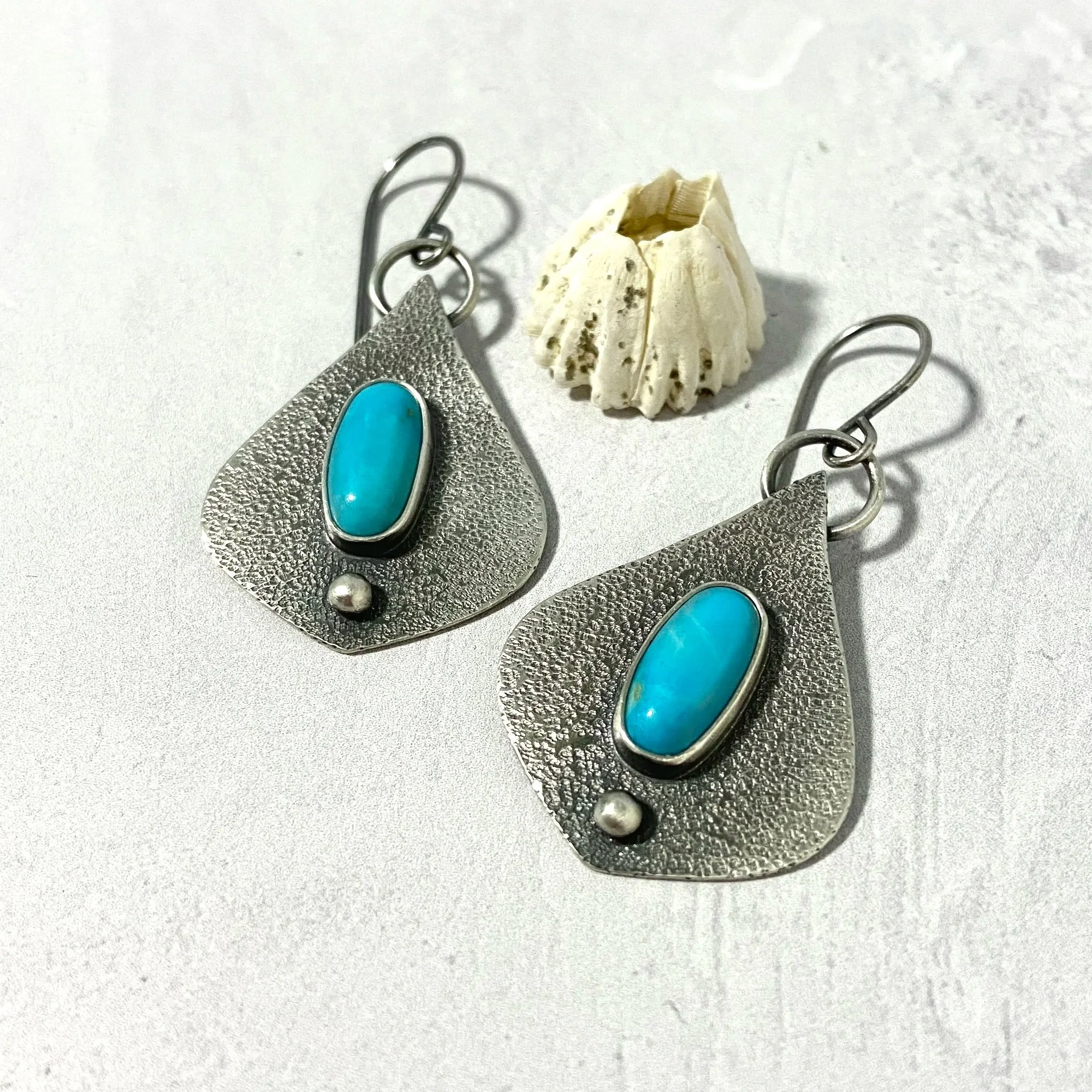 Moroccan shaped sterling silver earrings with kingman turquoise oval cabochons
