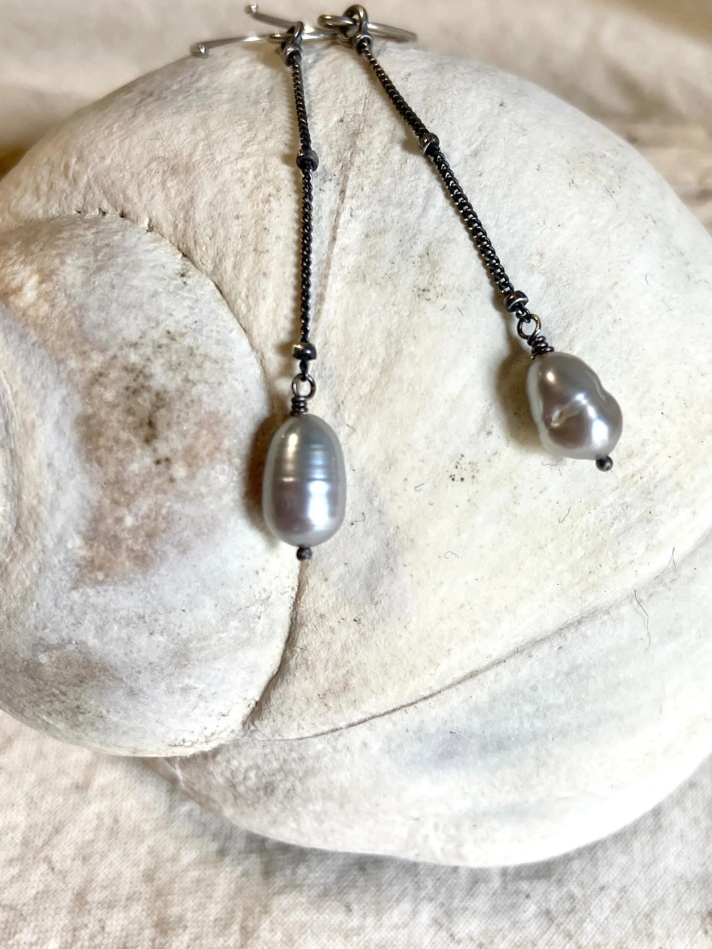 Elegant in their simplicity, these threader earrings are a modern take on the traditional pearl earrings. Gray freshwater pearls are not typical, but stunningly beautiful nonetheless. These are super lightweight and have nice movement. Available now.
