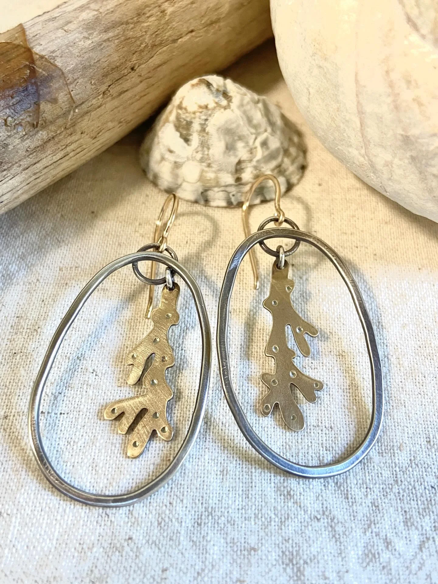 Silver hoops with brass coral dangles and 14k gold filled ear wires ~ 

Did you know that coral reefs cover less than 1% of the ocean floor, but they are home to more than 25% of all known marine species, making them one of the most biodiverse ecosys