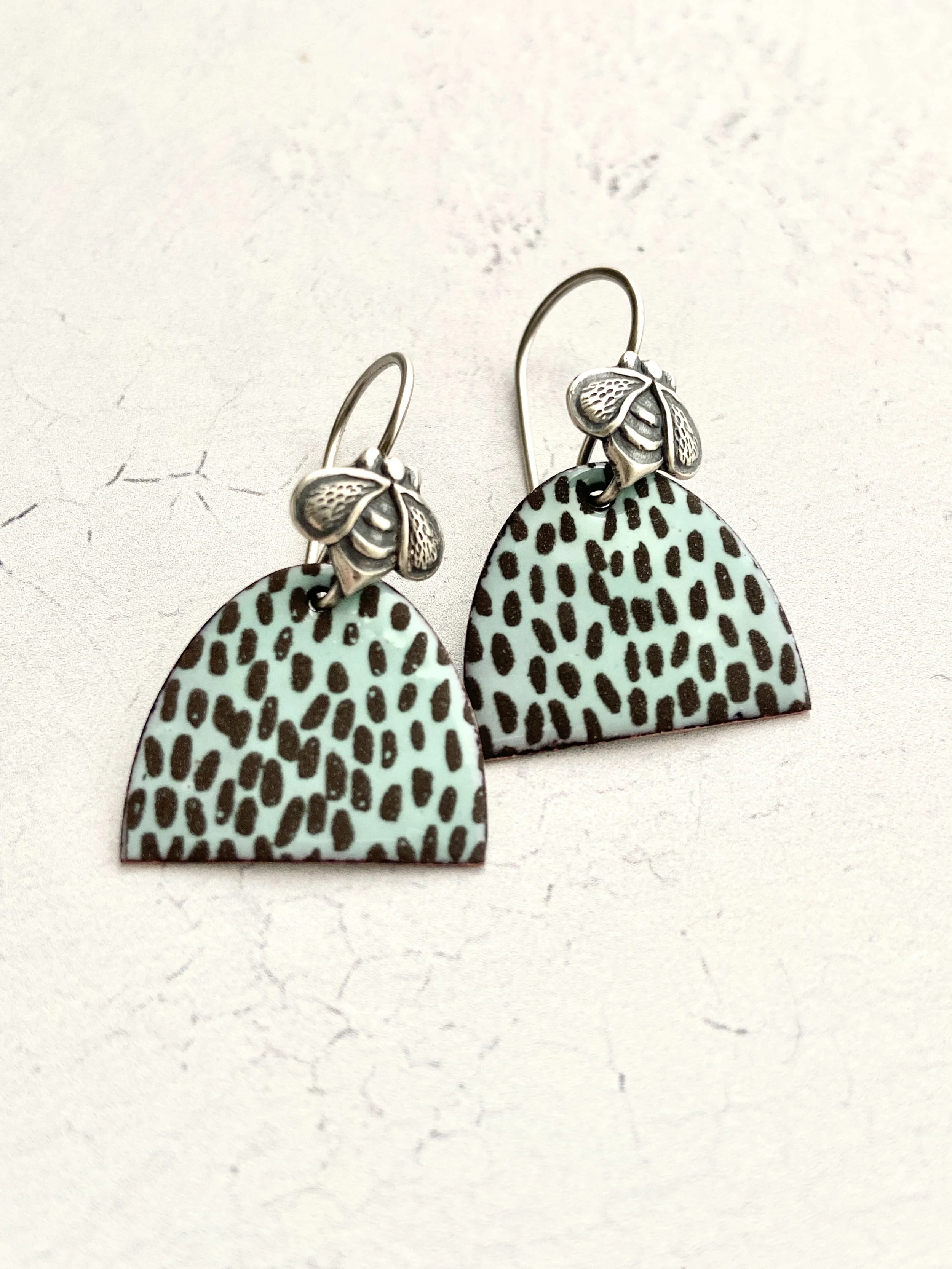 Enameled turquoise colored beehive shapes with brown silk screened speckles and sterling silver bee ear wires