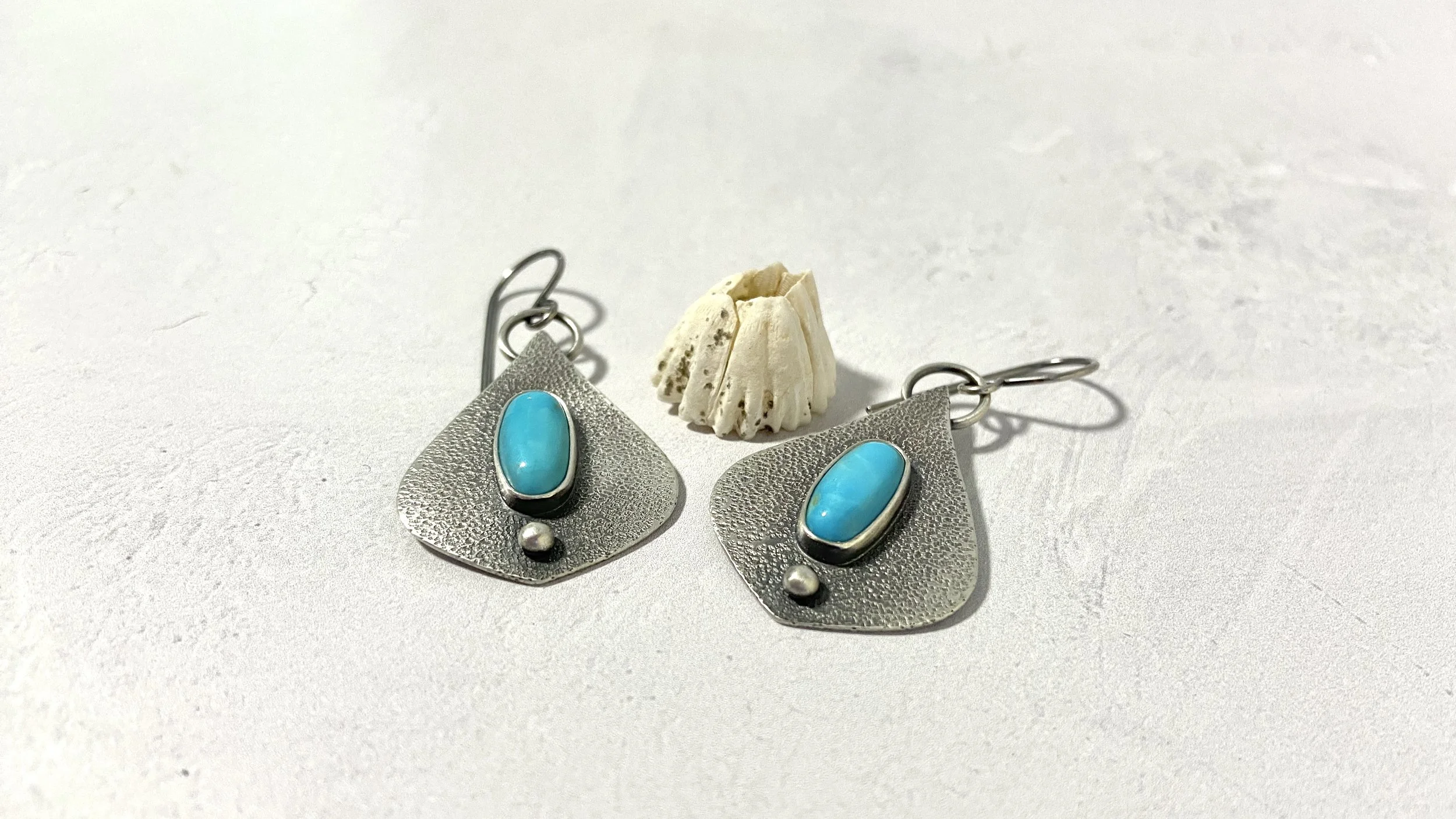 Moroccan shaped textured silver earrings with Kingman turquoise oval center stones