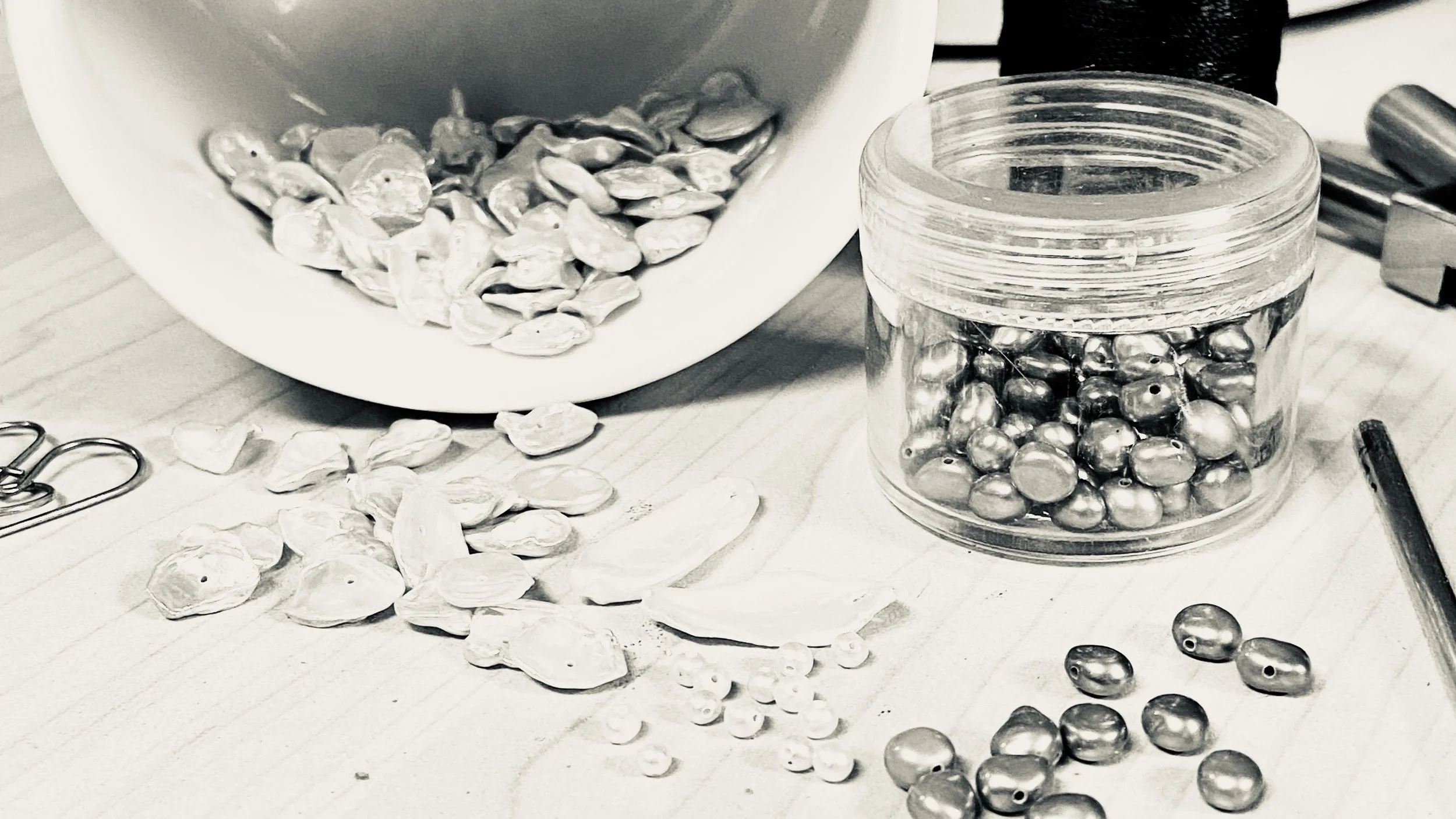 Loose pearls sitting on a jeweler's bench