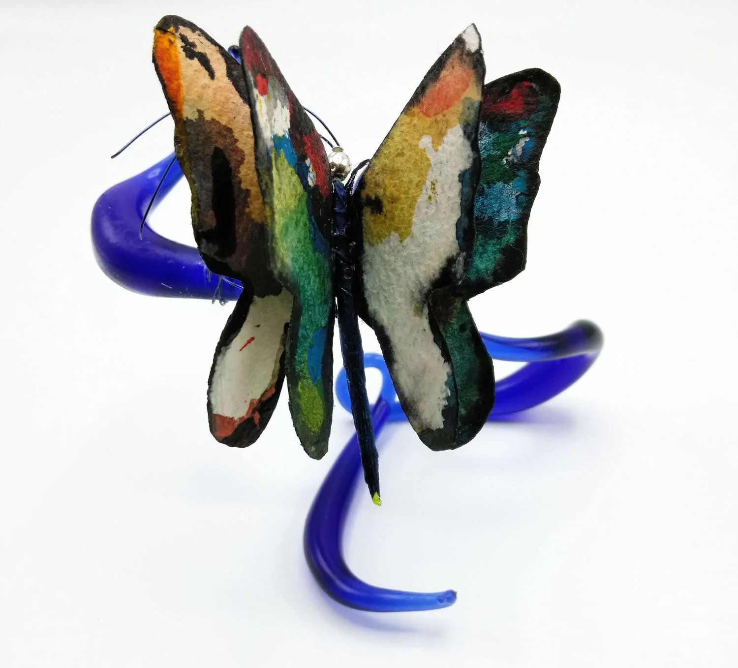Wind Surfer (view 3) Mixed media borosilicate, deep blue glass, flame work and abstract painting on cotton watercolor paper with orange glass beads at tips of antenna.. Wholesale Price: $100