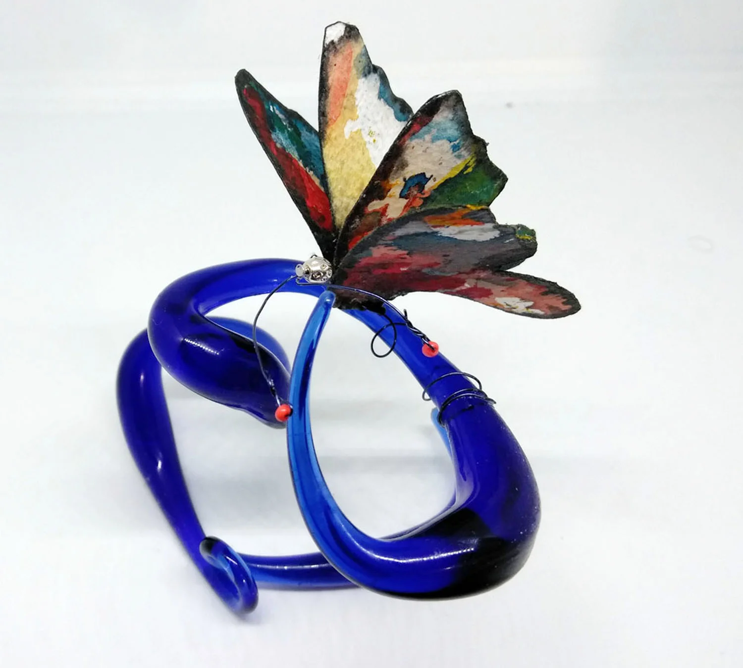 Wind Surfer (view 2) Mixed media borosilicate, deep blue glass, flame work and abstract painting on cotton watercolor paper with orange glass beads at tips of antenna.. Wholesale Price: $100