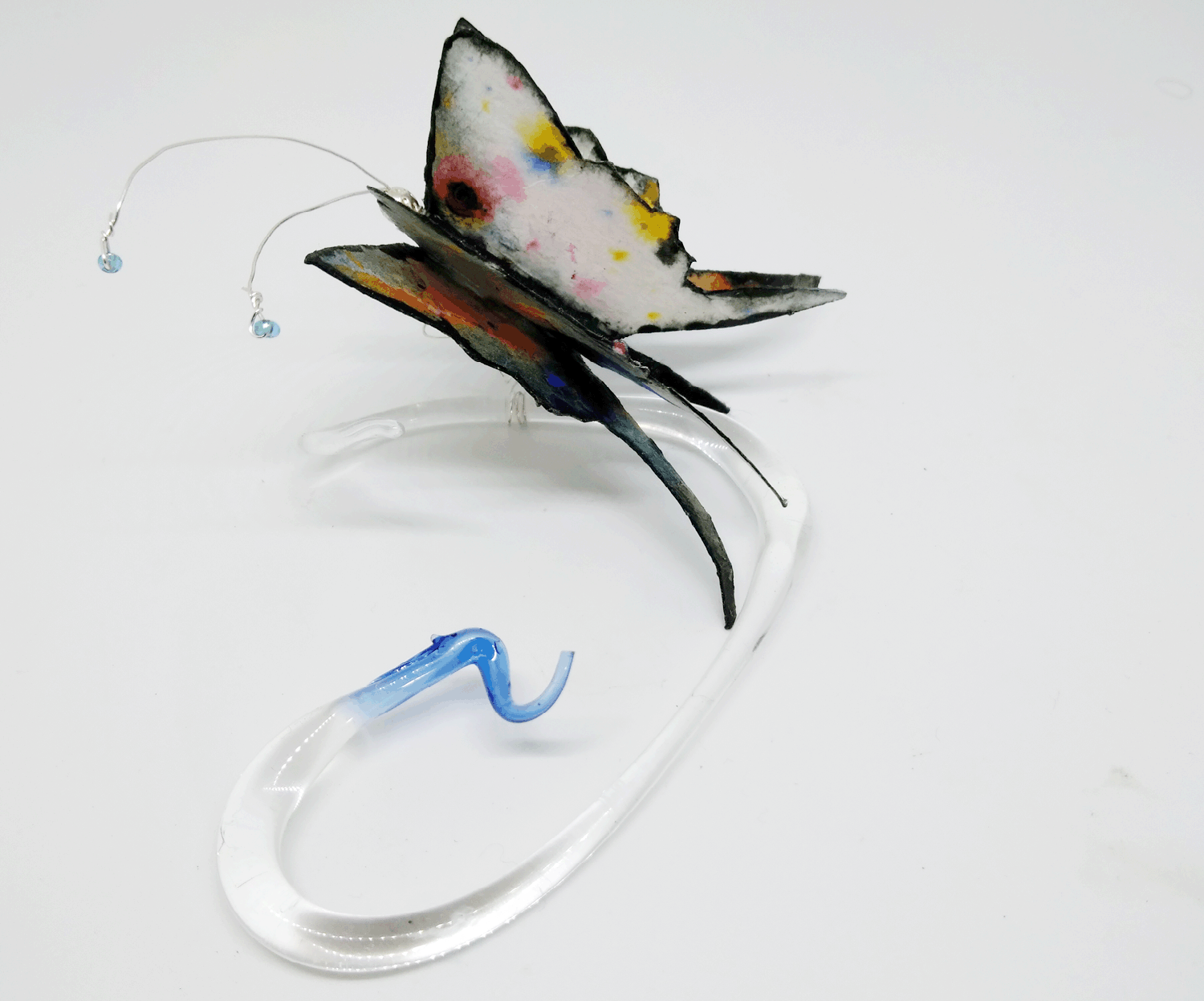 Whisked by A Cloud (view 3) Mixed media borosilicate, clear glass with blue tip, flame work tip and abstract painting on cotton watercolor paper with clear blue glass seed beads at tips of antenna... Wholesale Price: $95
