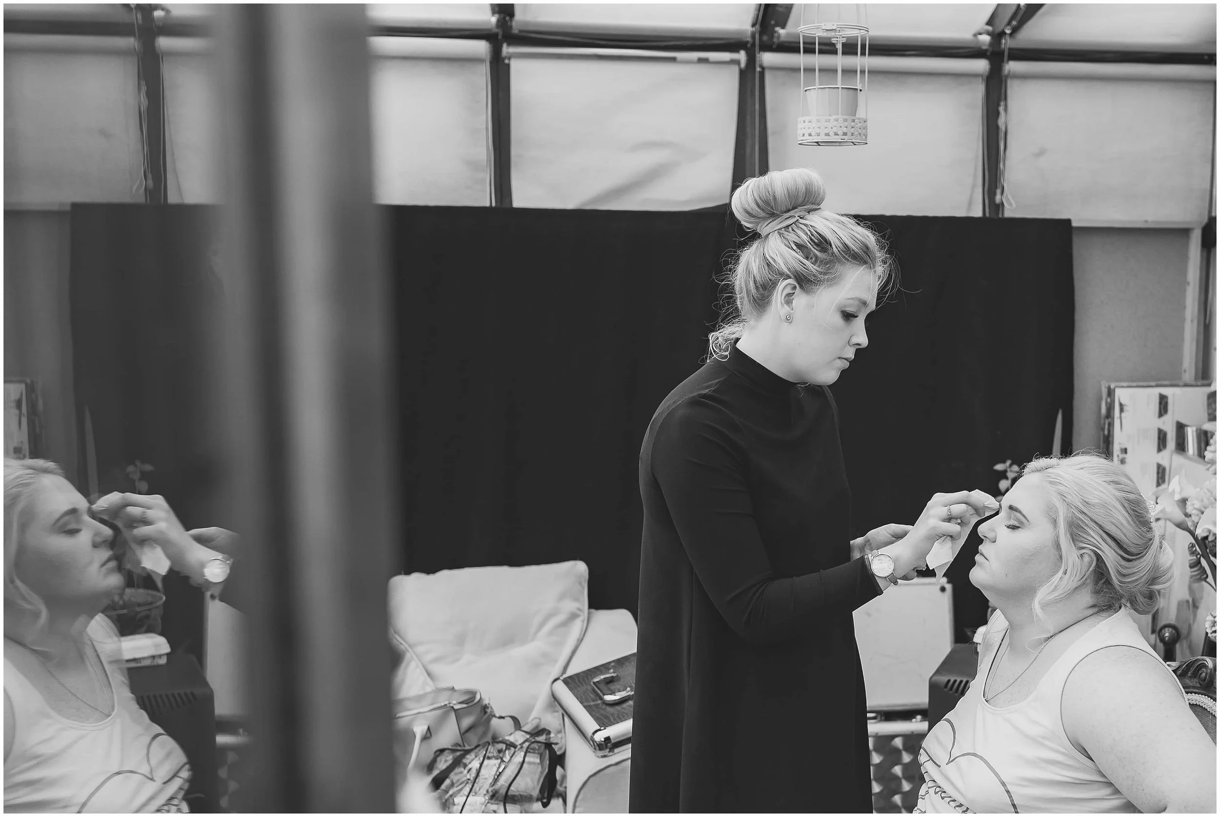 Bride getting makeup done captured by Surrey wedding photographer