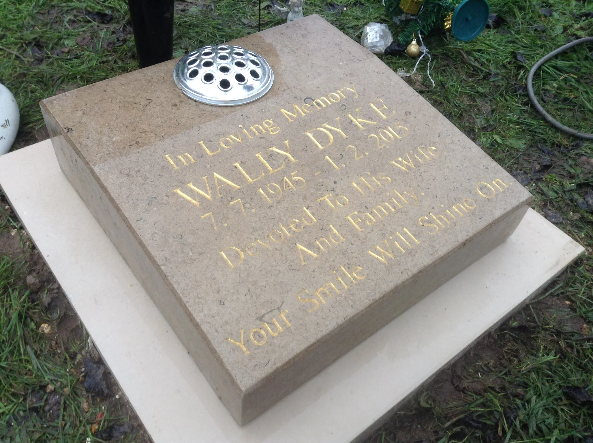 A Purbeck marble crematorium marker on a portland plinth