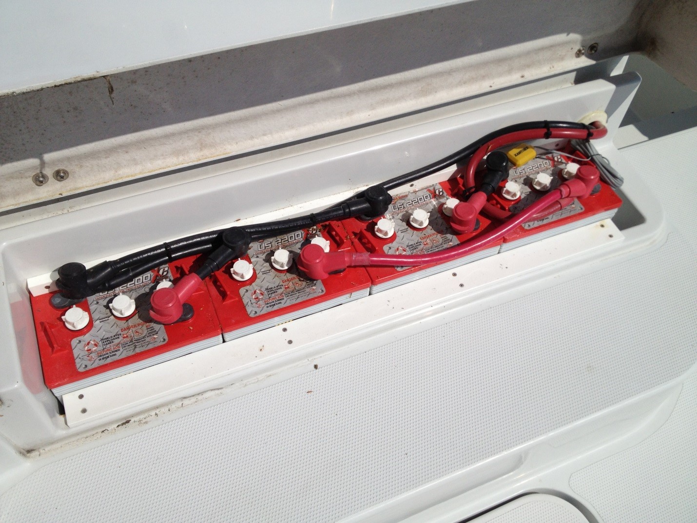 The ideal location of the house batteries under the flybridge step makes for easy maintenance and checking battery levels. These batteries have been replaced with taller Trojan T145s.