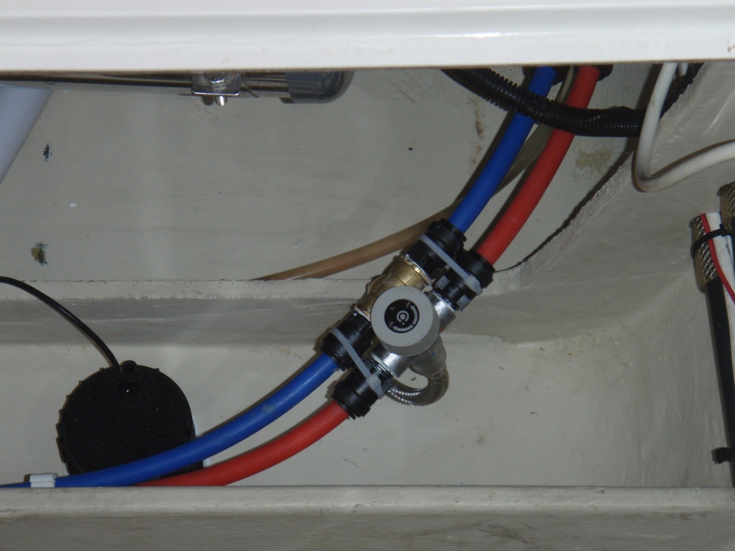 The Quick mixing valve (Quick is an Italian company which made the hot water heaters on the boat) connects hot and cold water to more safely and efficiently manage hot water. Such mixing valves should be standard on every cruising boat.