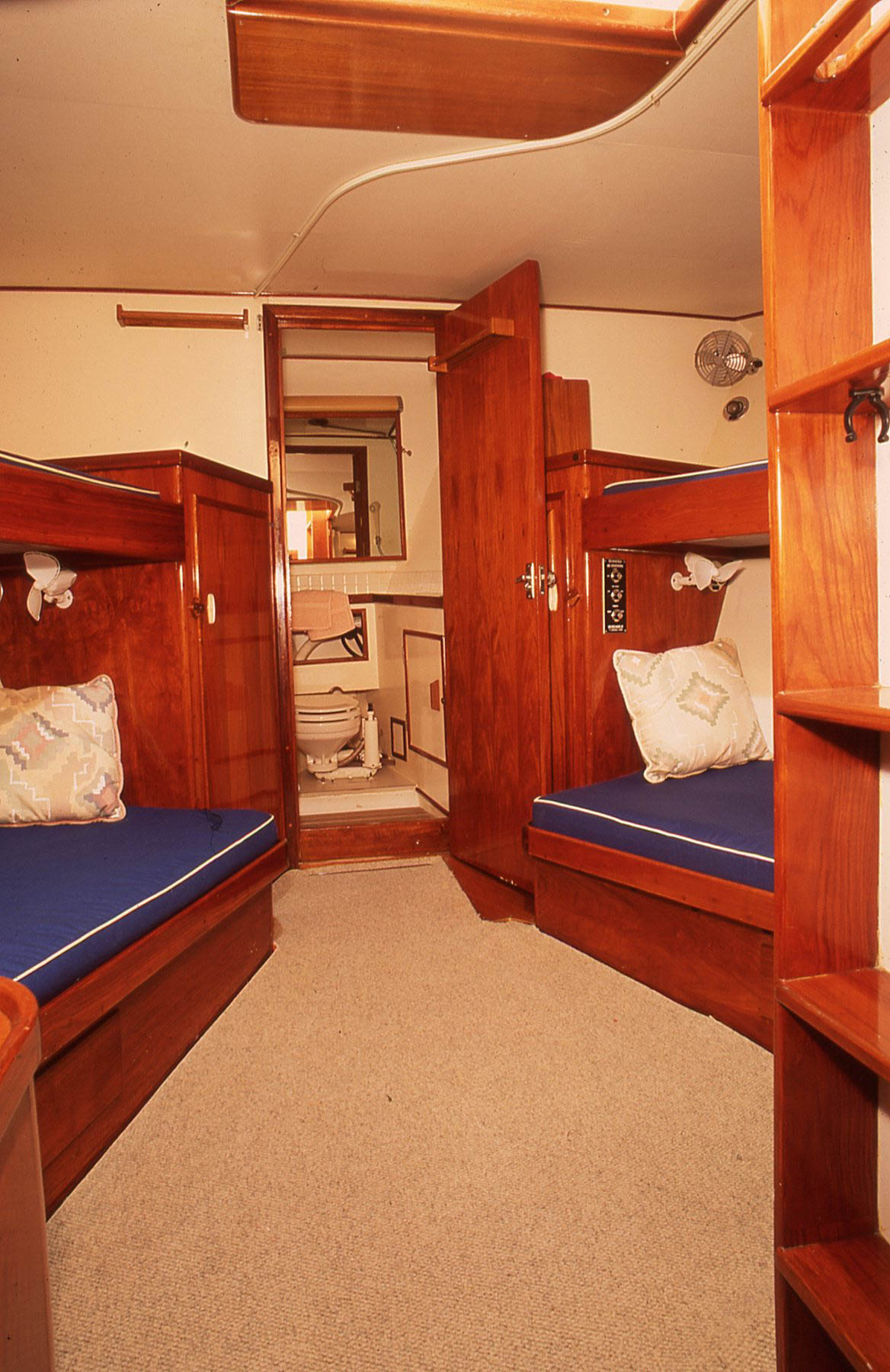 This guest stateroom with four roomy berths with plenty of headroom for crew to relax and read books. The guest head is forward.