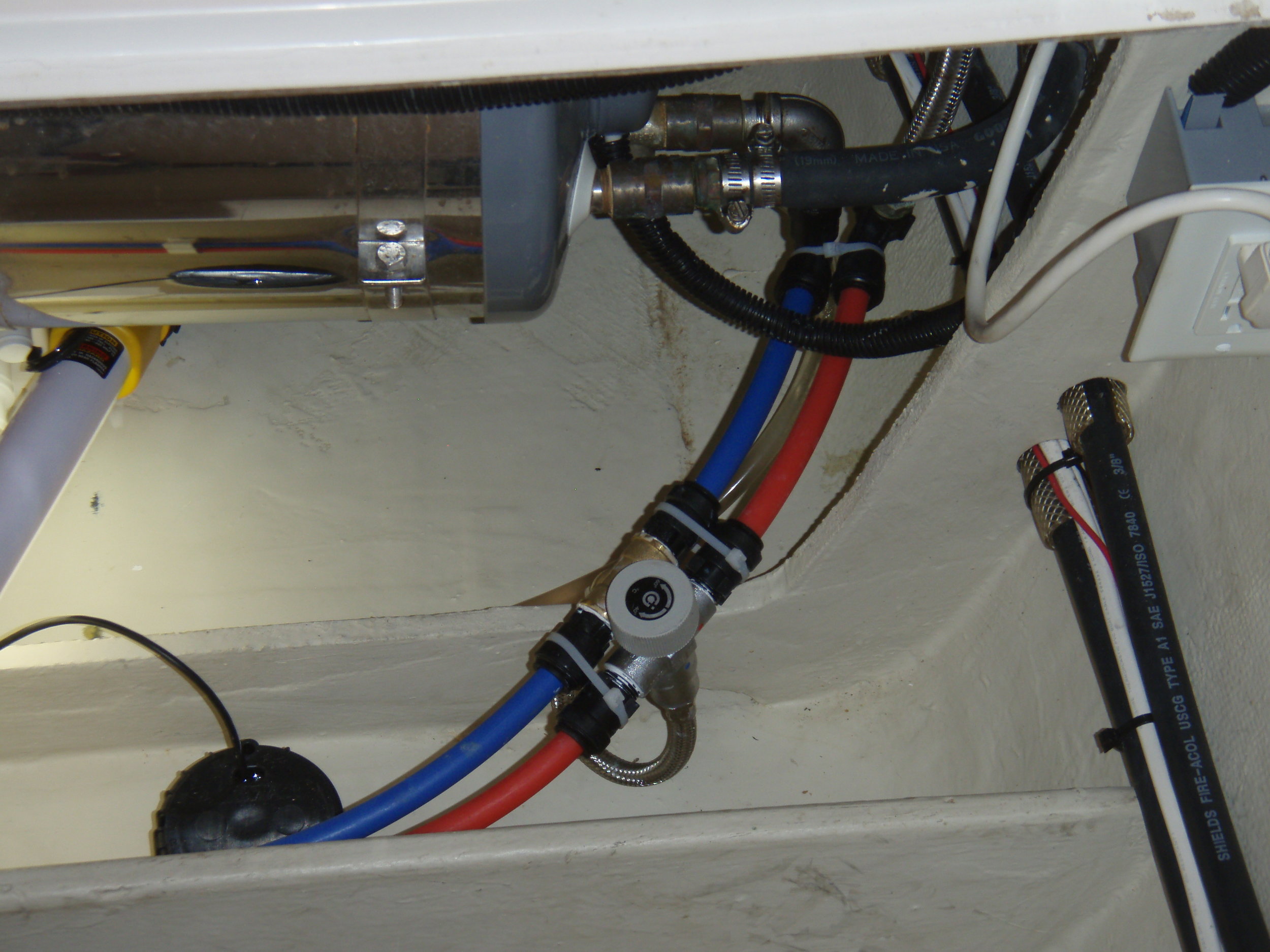 Every boat should be equipped with a mixing valve, which blends cold water into the extremely hot water coming out of the engine-heated hot water tank. Keeping the hot water temperature to no higher than 125 degrees is a critical safety priority. It is not a big project to tackle.