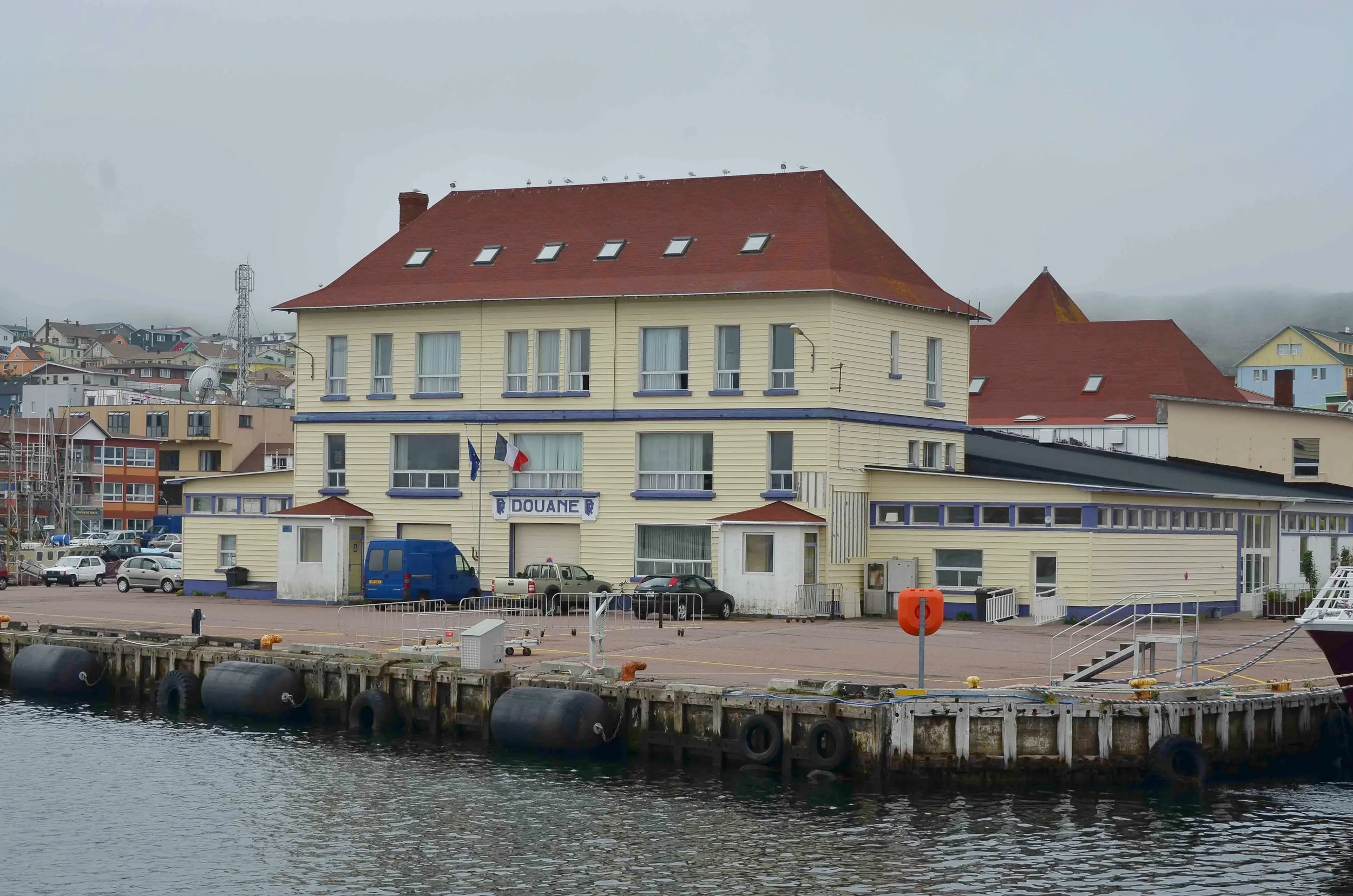 Douane or Customs House for St Pierre. The yacht club where Egret berthed was just beyond Customs. Within minutes of landing Customs had us checked into St Pierre. While that was going on crowds began forming and we met a number of interesting locals, one of which was an avid photographer who gave us the tip to photograph the small outlying island in soft afternoon light.