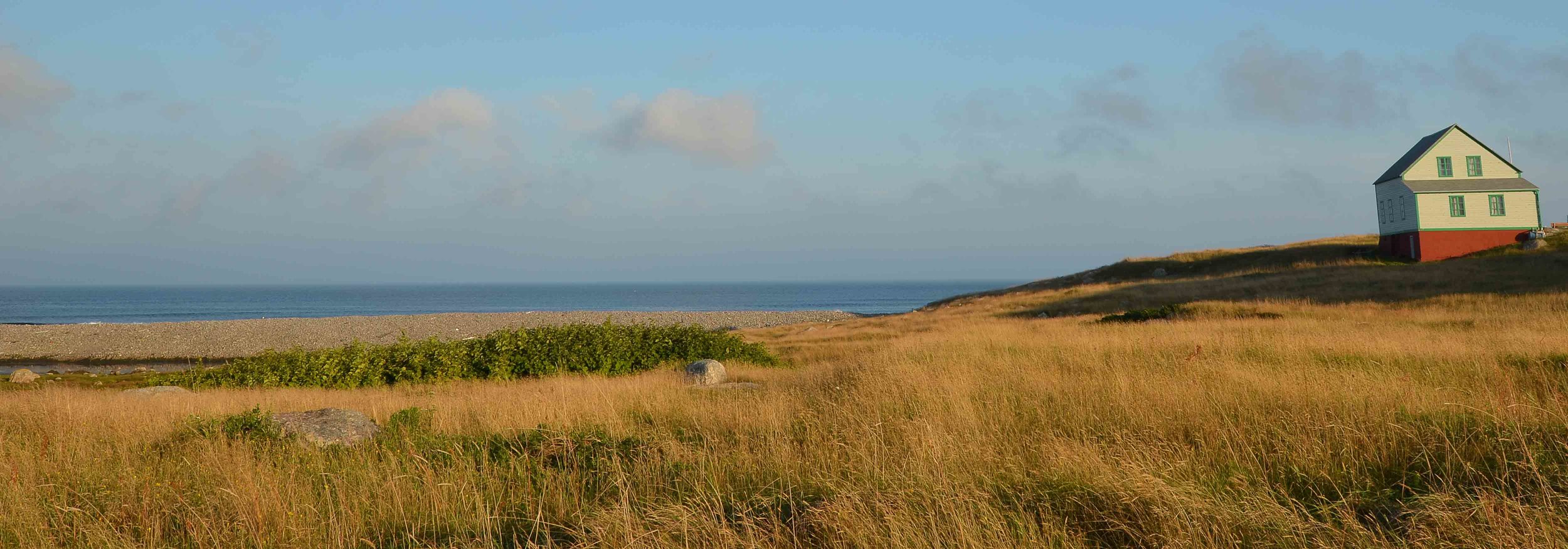 Mary’s favorite photograph she took at the island off St Pierre. It’s a Wyeth type setting. Not far away on the beach was my favorite photograph; a ship lying on its side with a small cottage in the background.