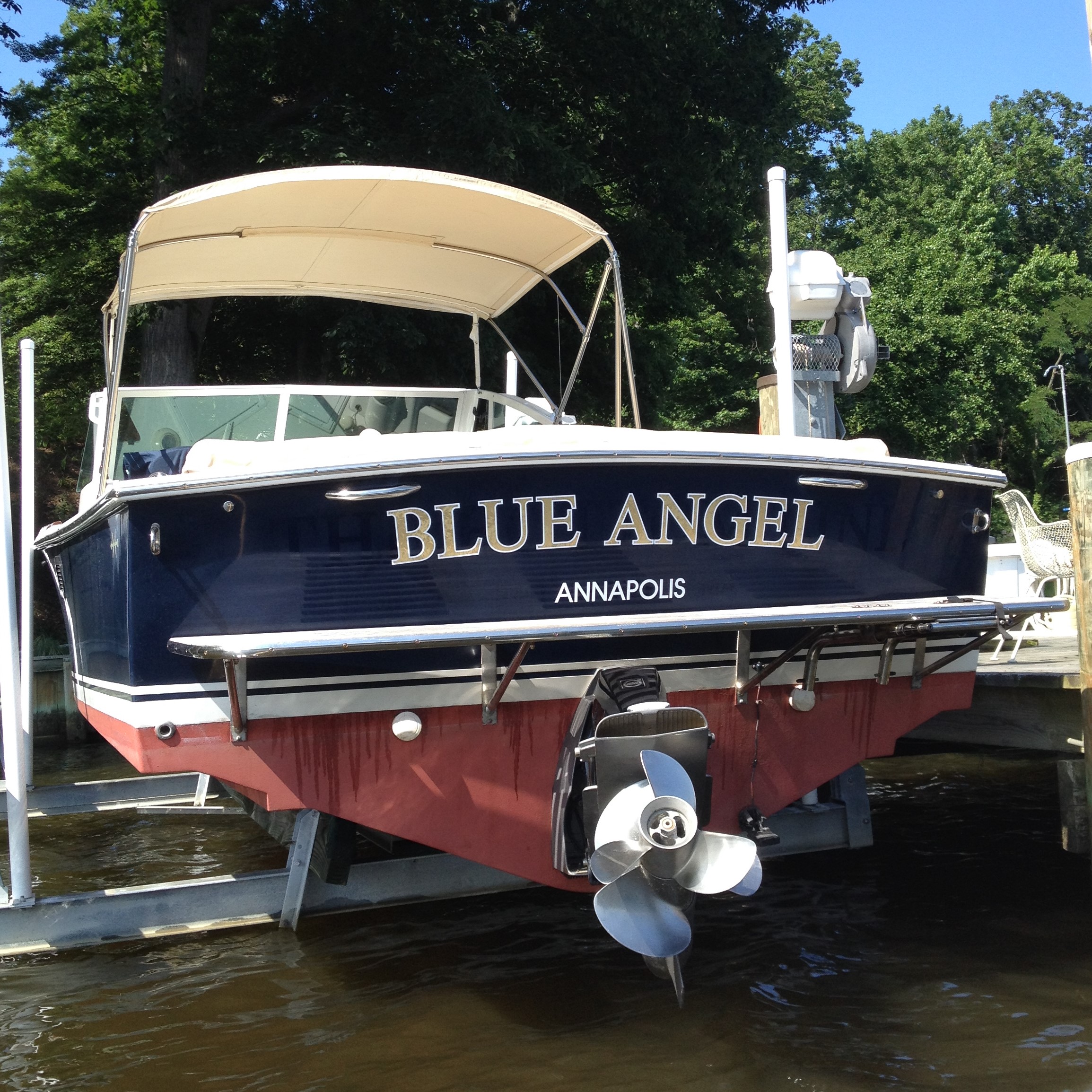 Soon after we bought Blue Angel , all bright and shiny, only a couple of years ago. Note the two handholds on the transom.