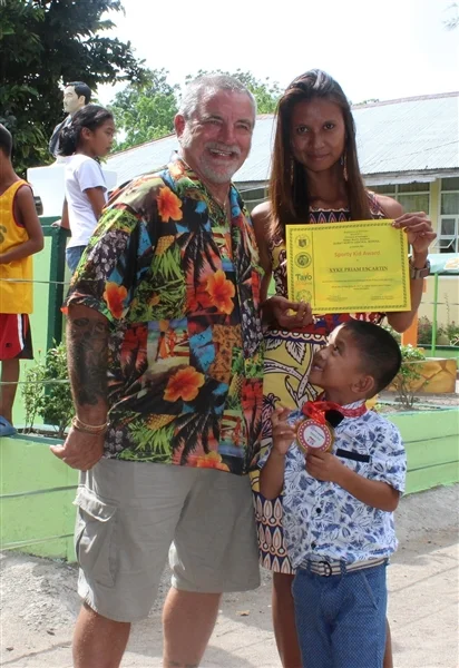 Brian and Donna celebrate the kindergarden graduation of her son, Piam.