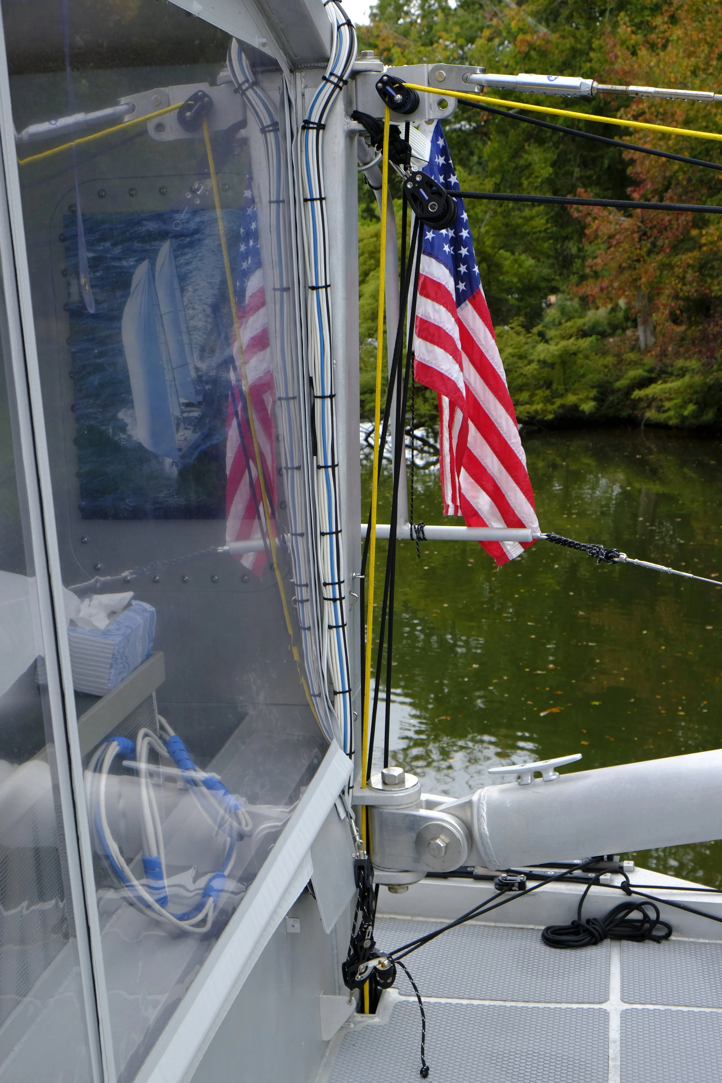 Lines run down to the aft deck, where they are handled from the safety of a protected location. There is no need for balancing off a cambered deck to launch or retrieve the dinghy.