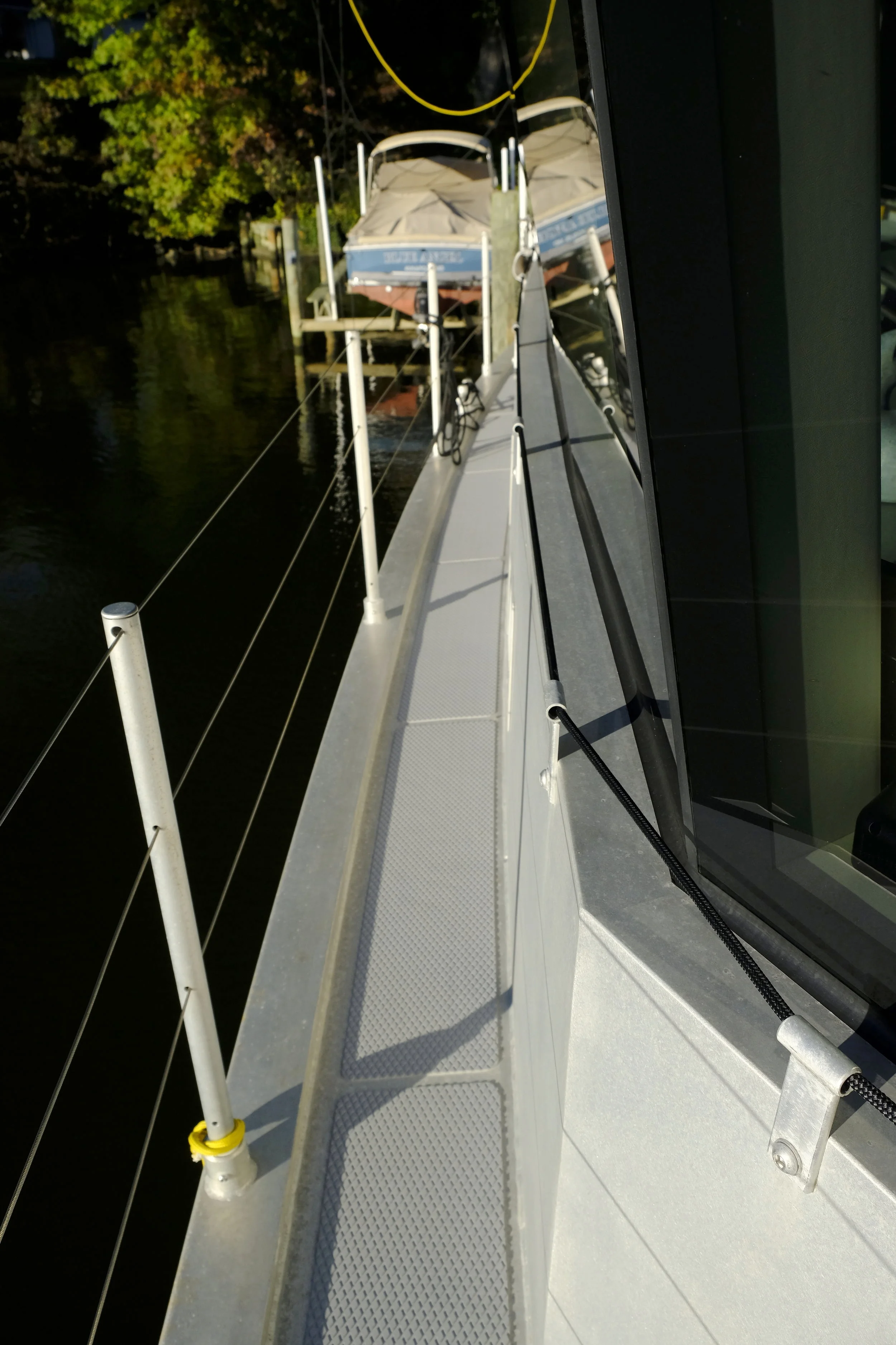Spectra line makes a great hand hold while moving along side decks. The line runs through brackets that attach using the threaded holes created for the boat's storm shutters.