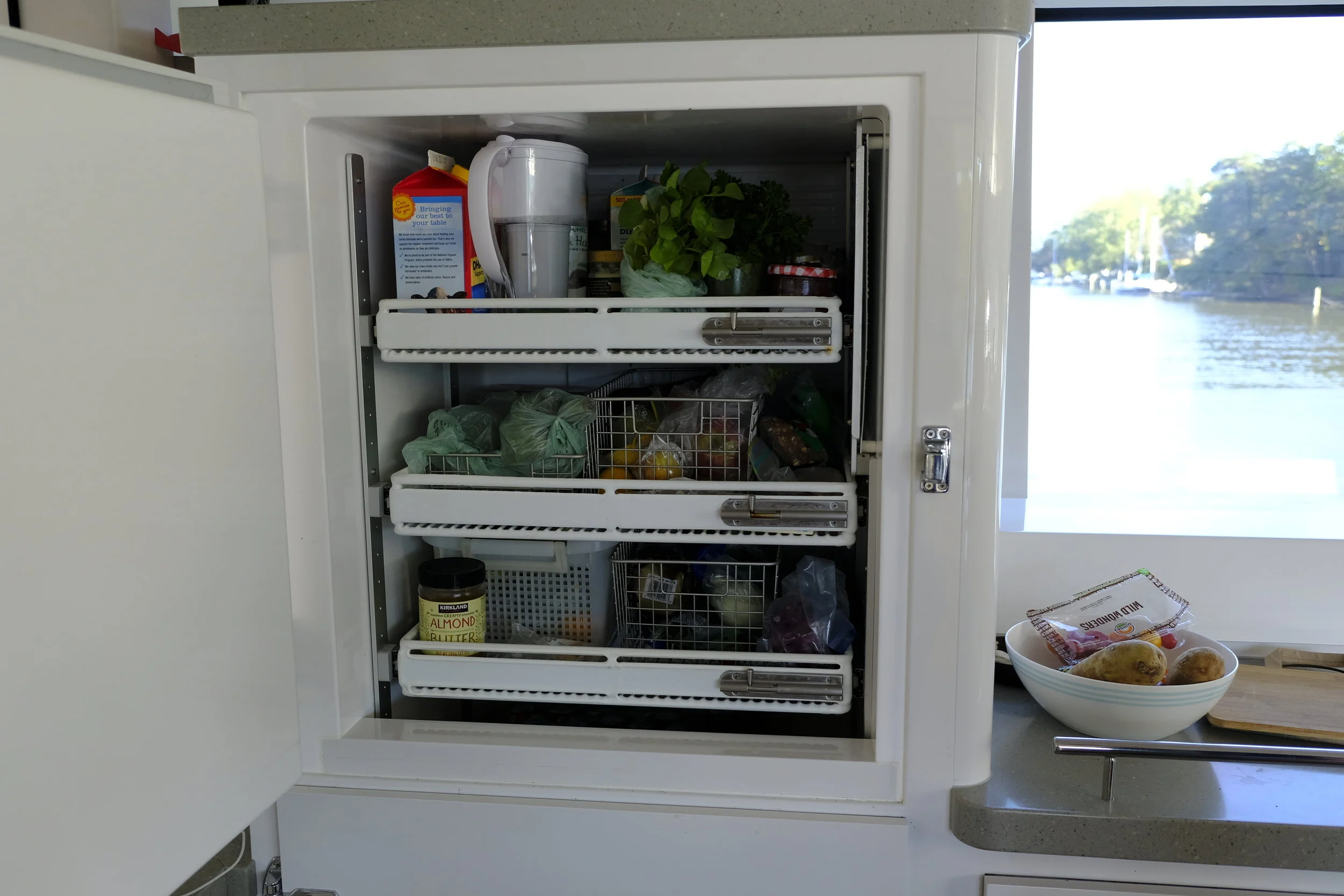 The two refrigerators have sliding shelves that can be adjusted in height, and locked into place under way. This is the best arrangement I have seen on a boat with side access.