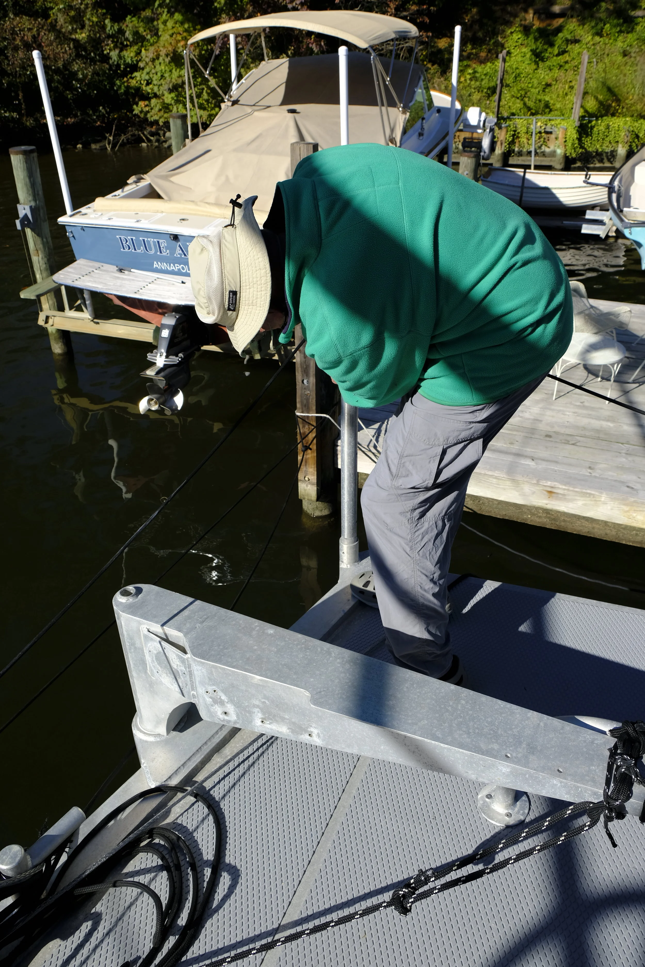 Steve demonstrates how easily this stanchion post can be lowered so the RIB can be slid off and launched in an emergency.  Cochise  does not carry a liferaft, and the RIB and crew immersion suits are the life-saving gear on this boat. That makes so much sense, as operating the RIB is very familiar, everyone uses it on a regular basis, and it can provide an active means of self rescue.  Liferafts are a different story altogether. One never knows if it will even inflate. (Years of doing Safety at Sea seminars confirm that even demo rafts sometimes don't inflate or don't hold air.) And of course, the crew just huddles together in a liferaft. waiting to be rescued. A more modern view is to encourage a self rescue effort, while using all the latest electronic technology to be located and coordinate a rescue.