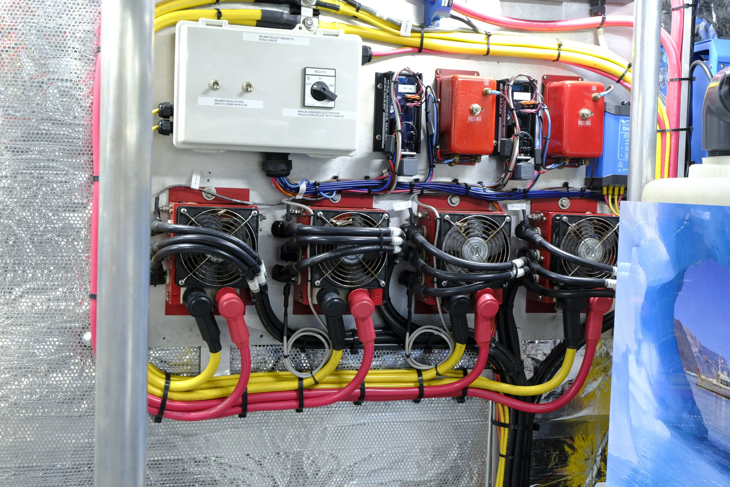 These four, remotely mounted bridge rectifiers (diode bridges) take the conversion from AC to DC out of the four engine-mounted alternators (two per engine), which removes heat from the alternators and reduces the single biggest point of failure of an alternator. This makes so much sense, and you might consider doing the same on your boat if your aim is to minimize points of failure.