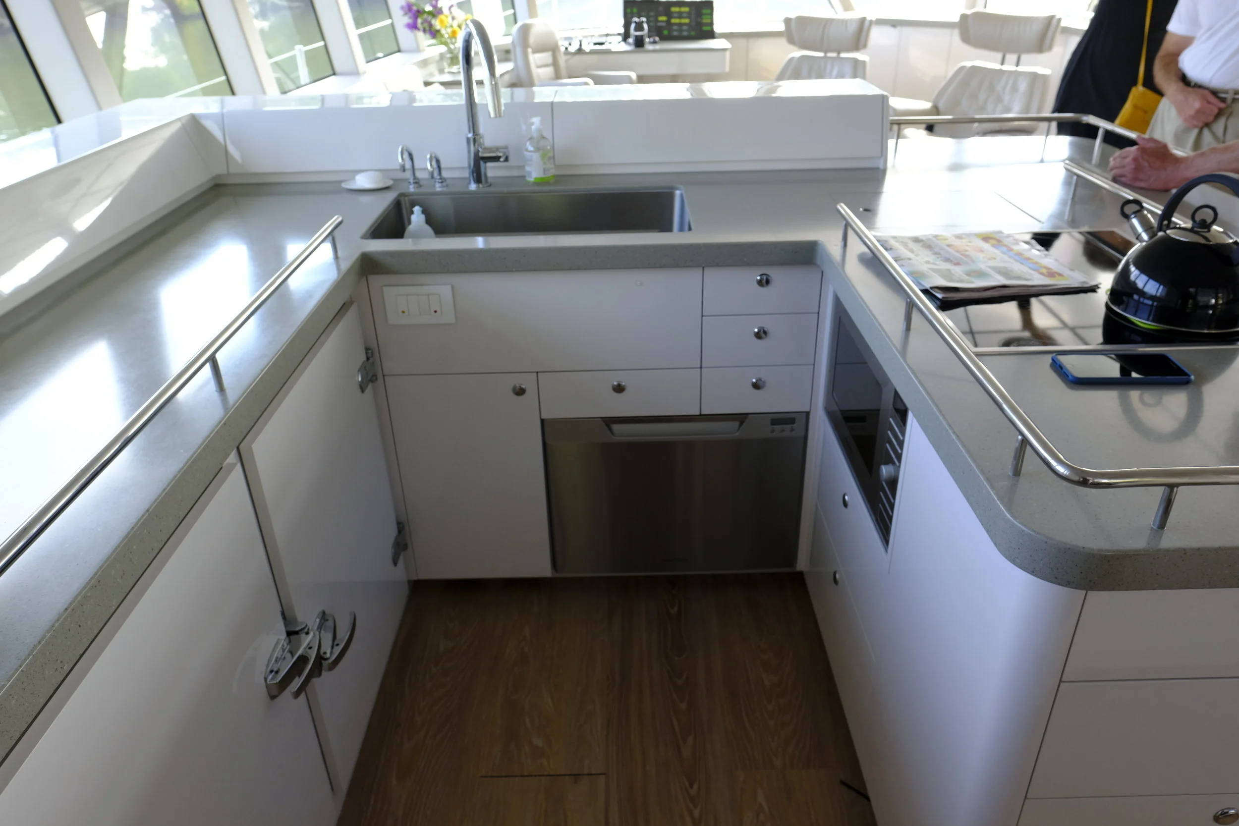 The boat's galley has everything one needs to make meals at sea or at anchor. Everything is put away, unlike the cluttered counters on most boats. Freezers to the left, dishwasher under the sink, and microwave on the right under the stovetop.