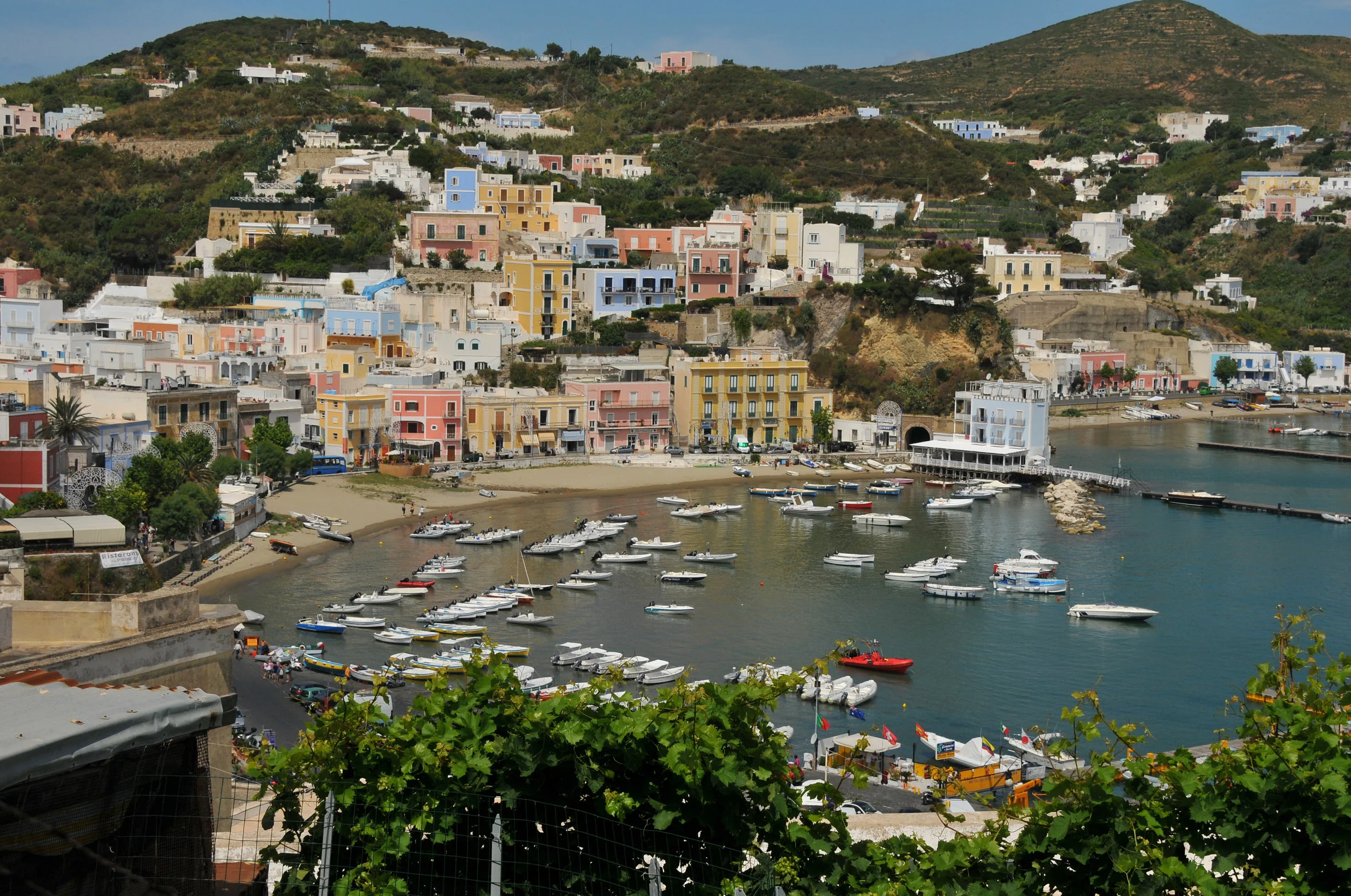 The small boat harbor at Ponza borders the larger fishing boat and commercial harbor. These boats are mostly rental boats. Egret’s dink is pulled up on the beach in front of the bright coral house left center.