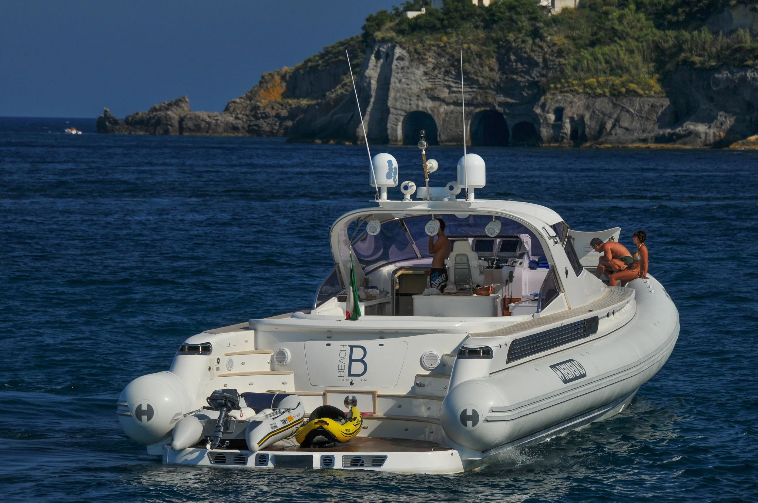 Heaven 80 inflatable, Beach B , approaching the Baths. After making the rounds through the anchorage, it anchored near Egret . Exercise girl is sitting up forward. Oh my.