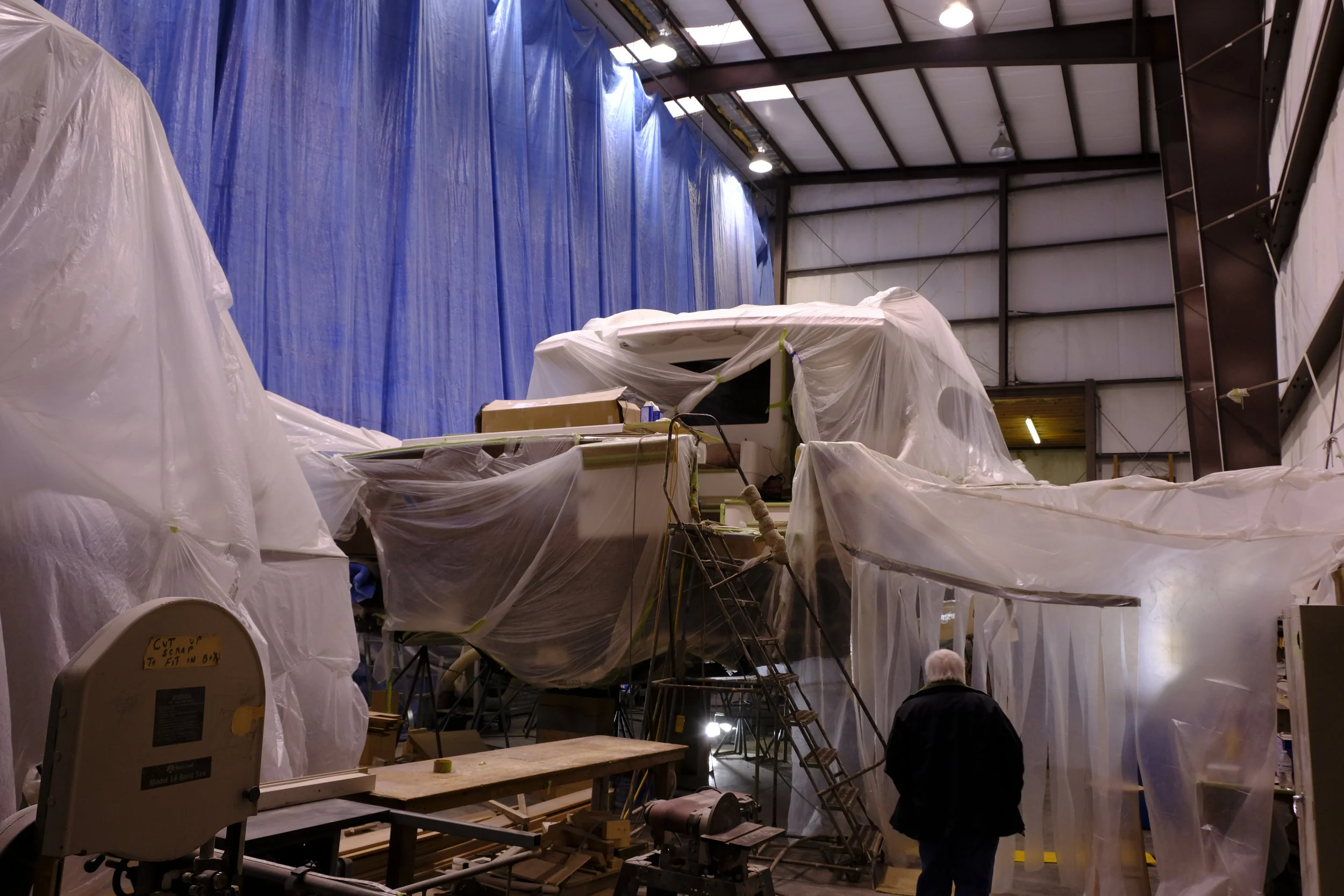 Hard to see behind all of the plastic, but there is a fabulous 74-foot sportfishing yacht front and center in this shed. The flybridge under the plastic to the left was cut off so the engines could be removed out of the top of the boat through a hole cut in the saloon sole. Not for the faint of heart!