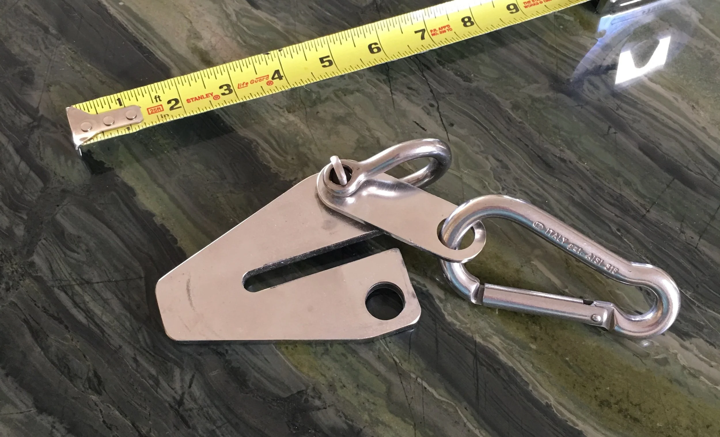 It is a simple job to slide the gate open and fit the hook around a link of chain then close the gate to keep the chain captive. In a pinch the shackle could be attached to one snubber line and both gate and carabiner left off. It would still work as a traditional chain hook. And for serious conditions or longer term anchoring, the carabiner could be replaced with another shackle.