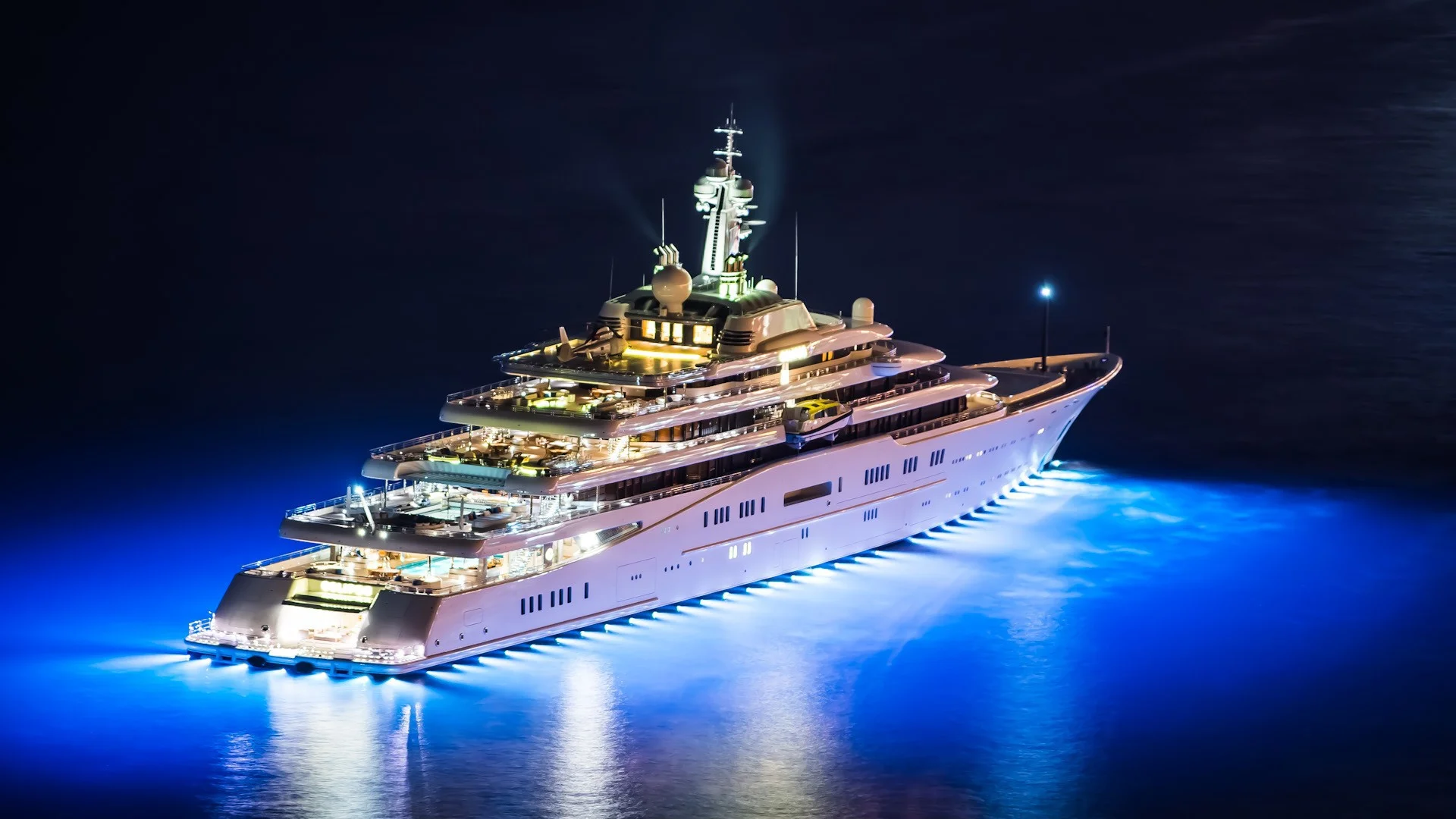 Perhaps this is a bit extreme, but it would be hard to sneak aboard a boat so well lit. Take control of your exterior lighting. Wire a system together that you can switch on from near your berth, at the helm, or other locations where it is easy to get to undetected in the dark interior.